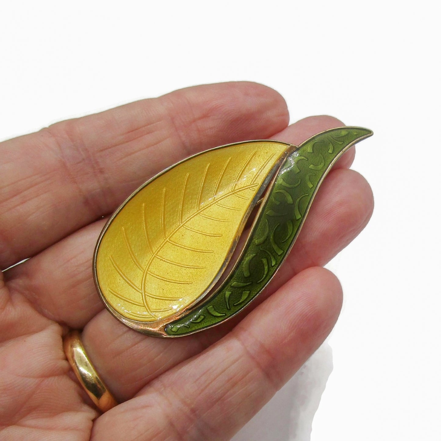 Aksel Holmsen Norway sterling silver gilt and enamel brooch shown held in a hand