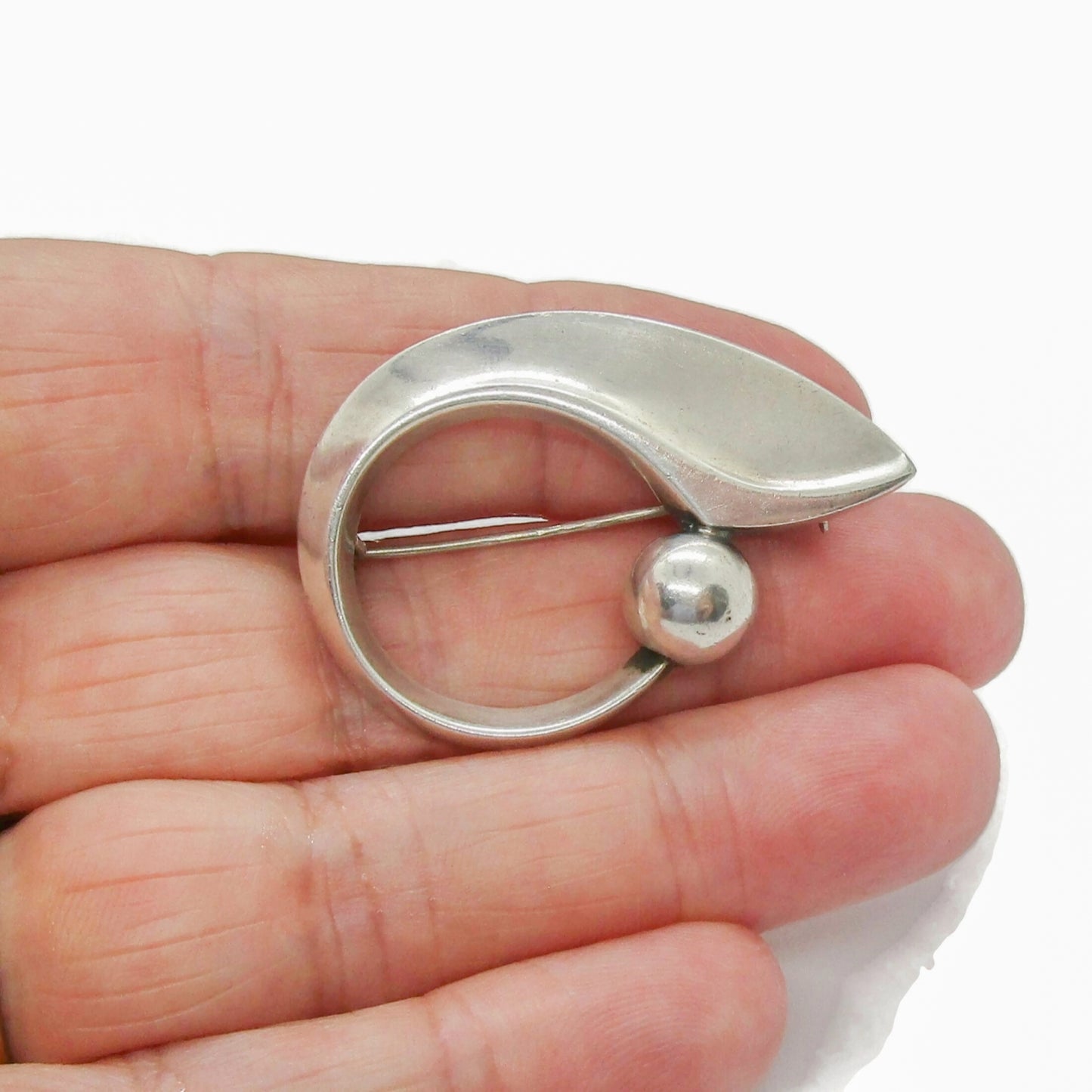 Hans Hansen Denmark sterling silver abstract brooch number 109 shown held in a hand