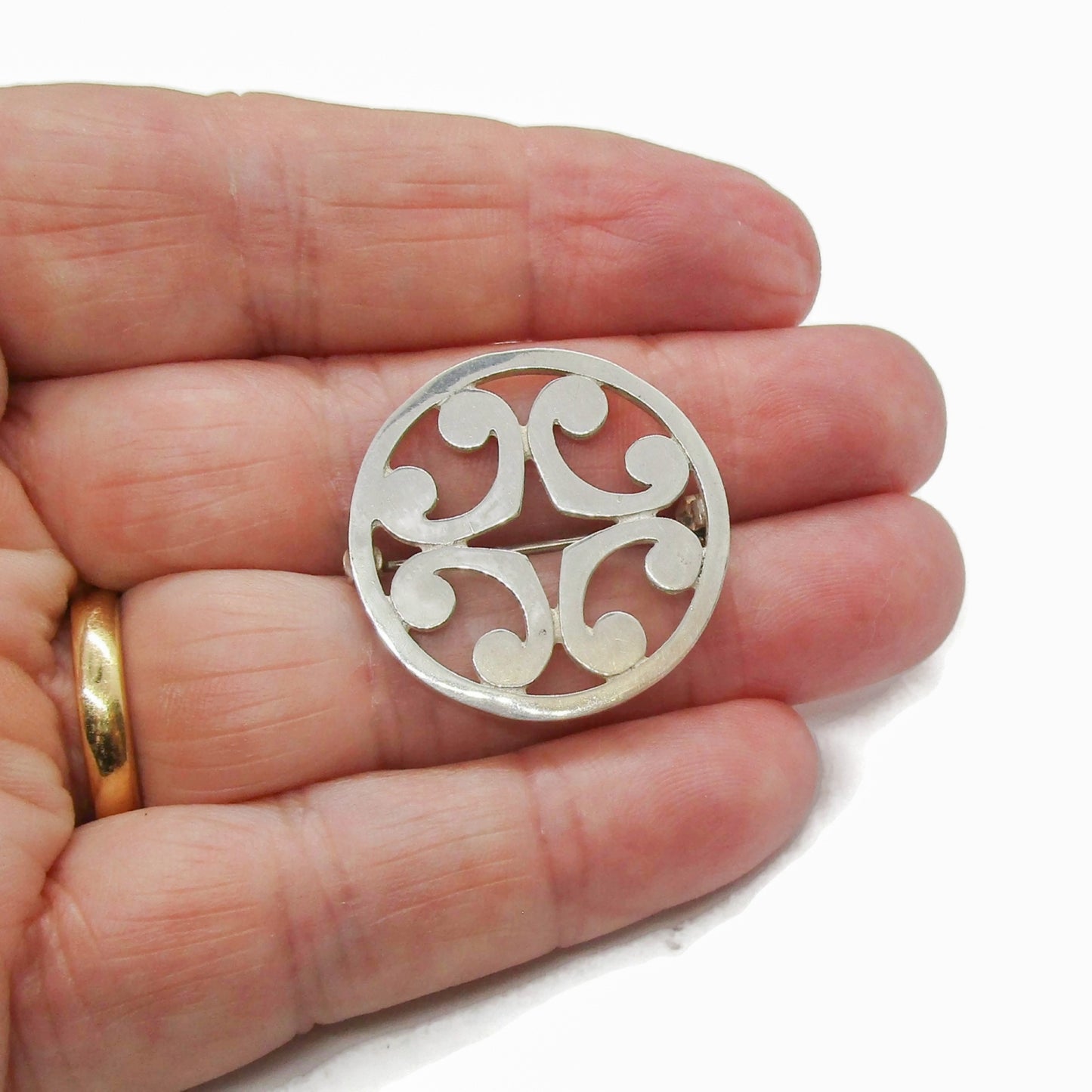 Malcolm Gray sterling silver St Magnus brooch shown held in a hand