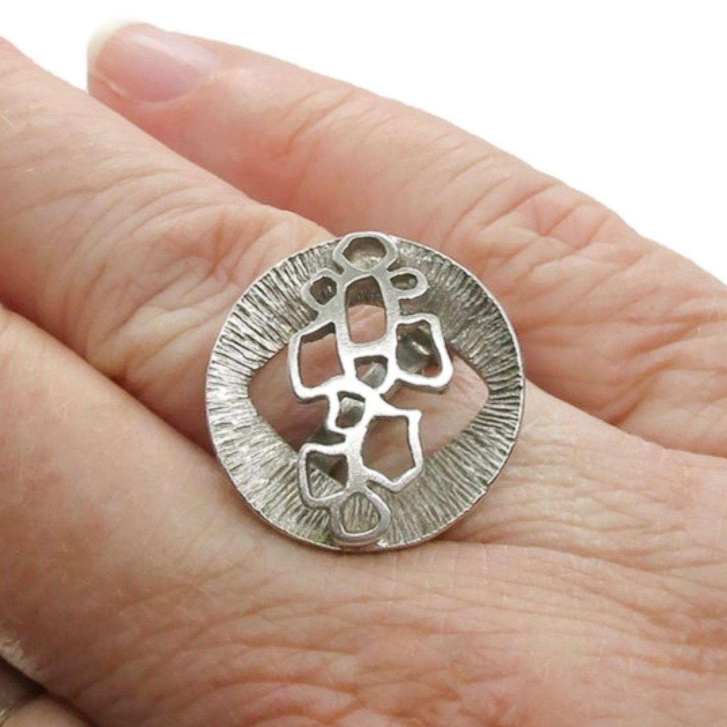A Unidor Germany sterling silver abstract ring shown worn on a finger