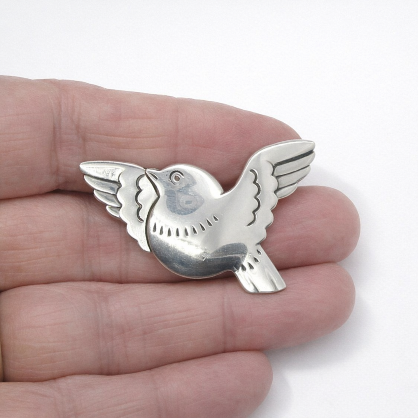 Georg Jensen Denmark sterling silver bird brooch number 320 held in a hand