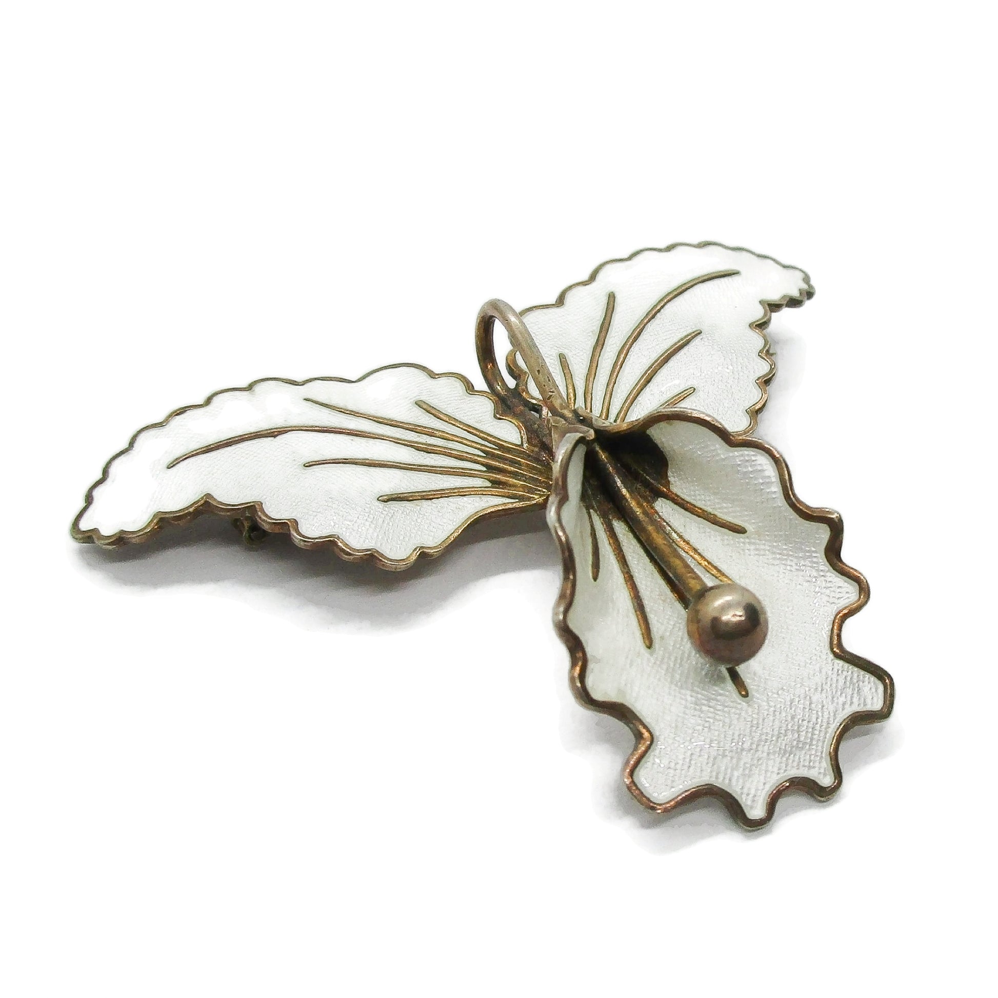 Close up of Aksel Holmsen Norway  sterling silver gilt and white enamel orchid brooch