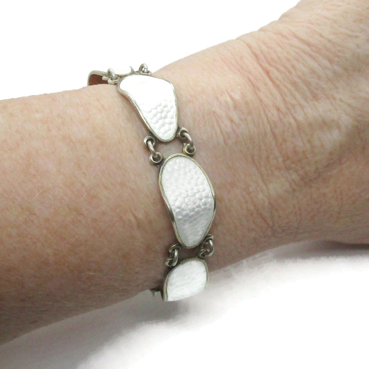 Aksel Holmsen sterling silver gilt and white enamel bracelet shown worn on wrist