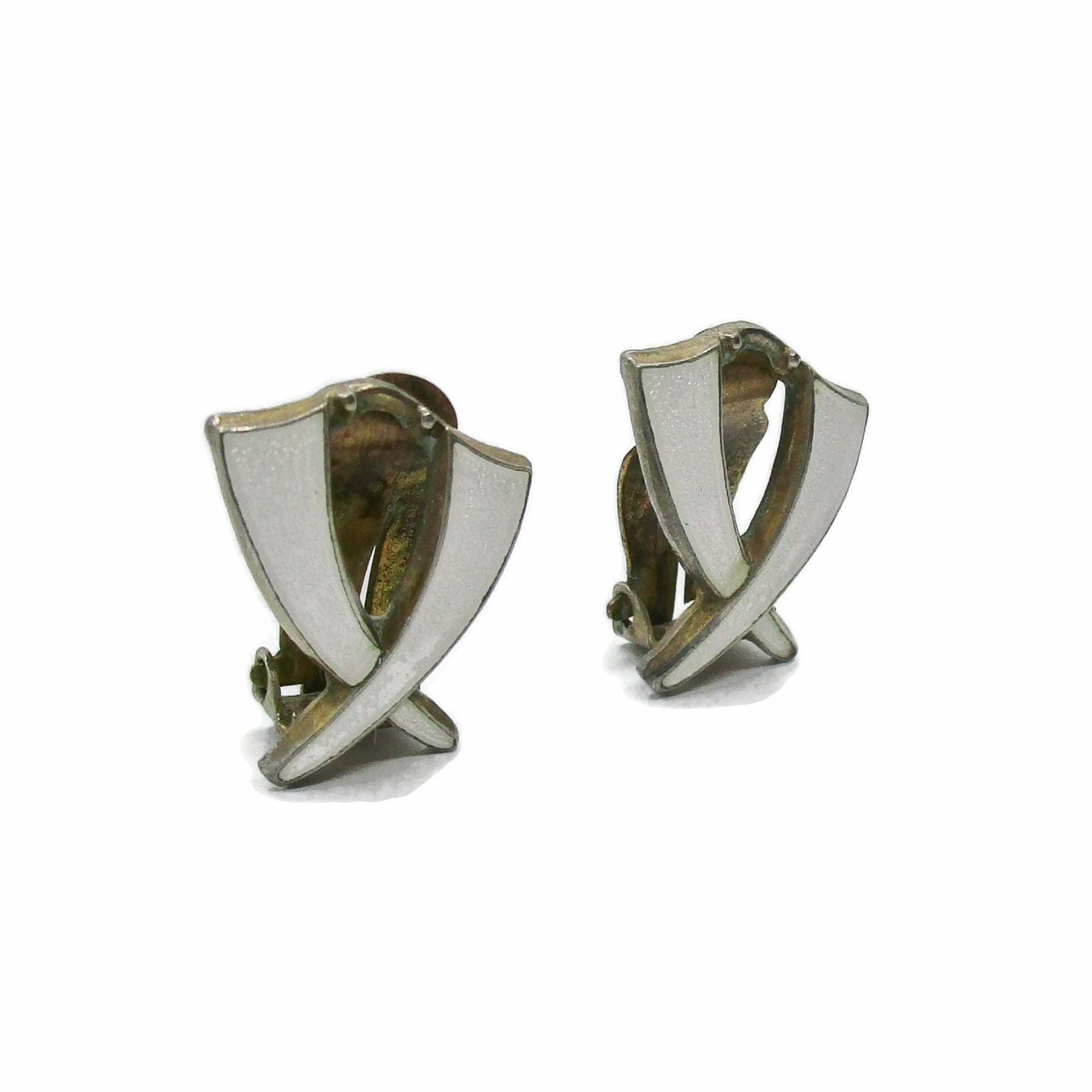 Angled view of a pair of Aksel Holmsen Norway sterling silver and enamel clip on earrings in a cross design