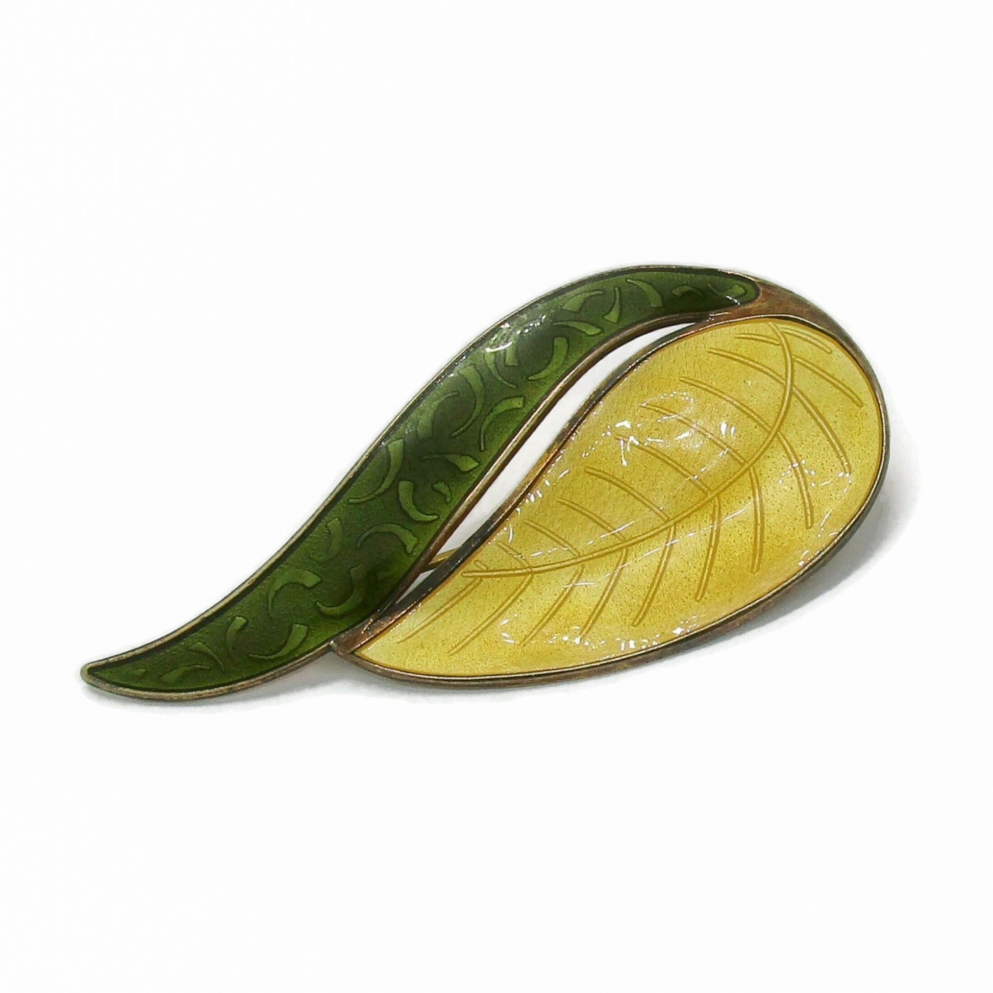 Angled view of an Aksel Holmsen Norway sterling silver gilt and enamel brooch