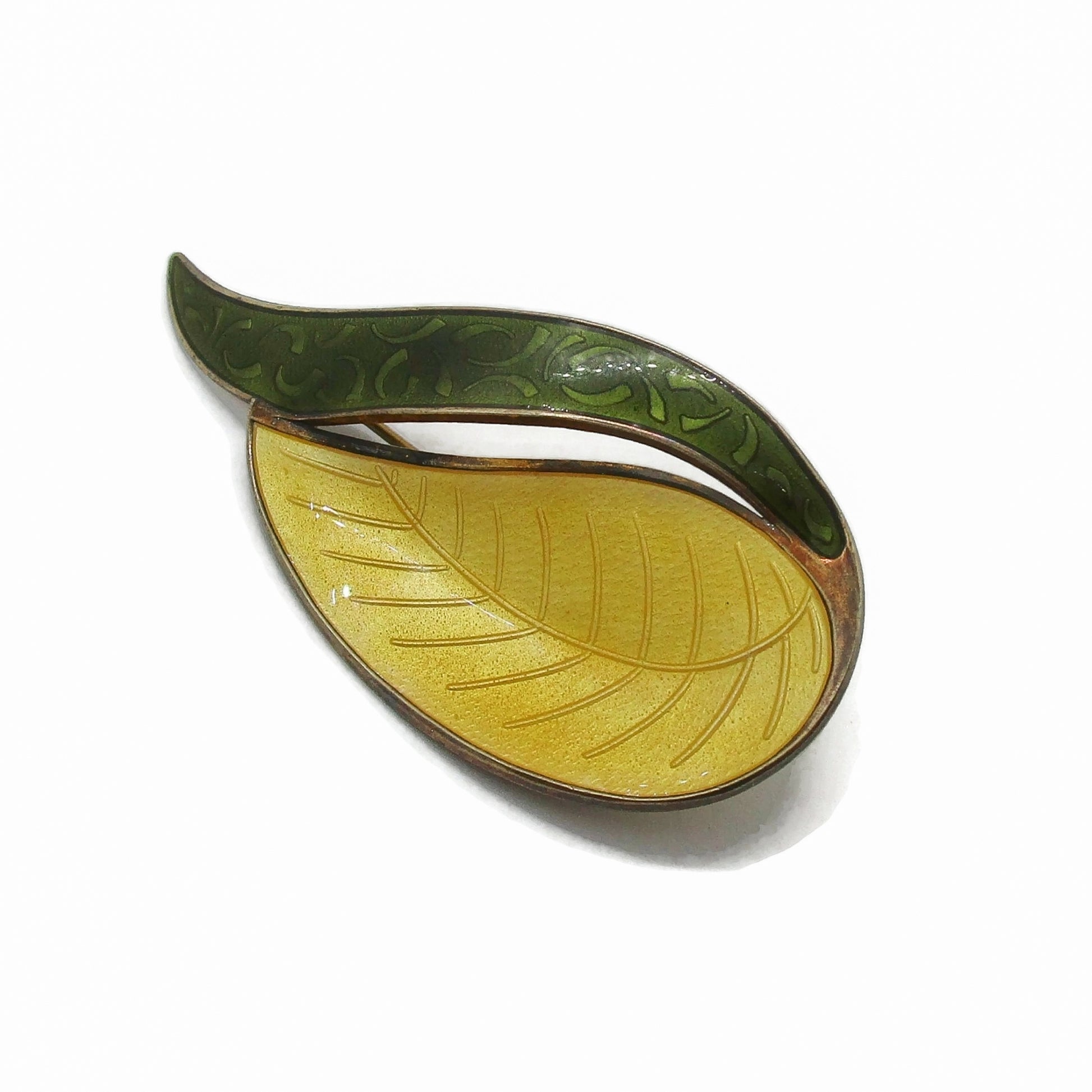 Close up view of an Aksel Holmsen Norway sterling silver gilt and enamel brooch