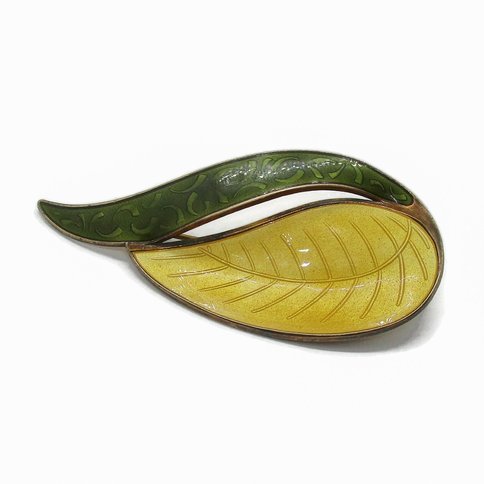 Front view of an Aksel Holmsen Norway sterling silver gilt and enamel brooch