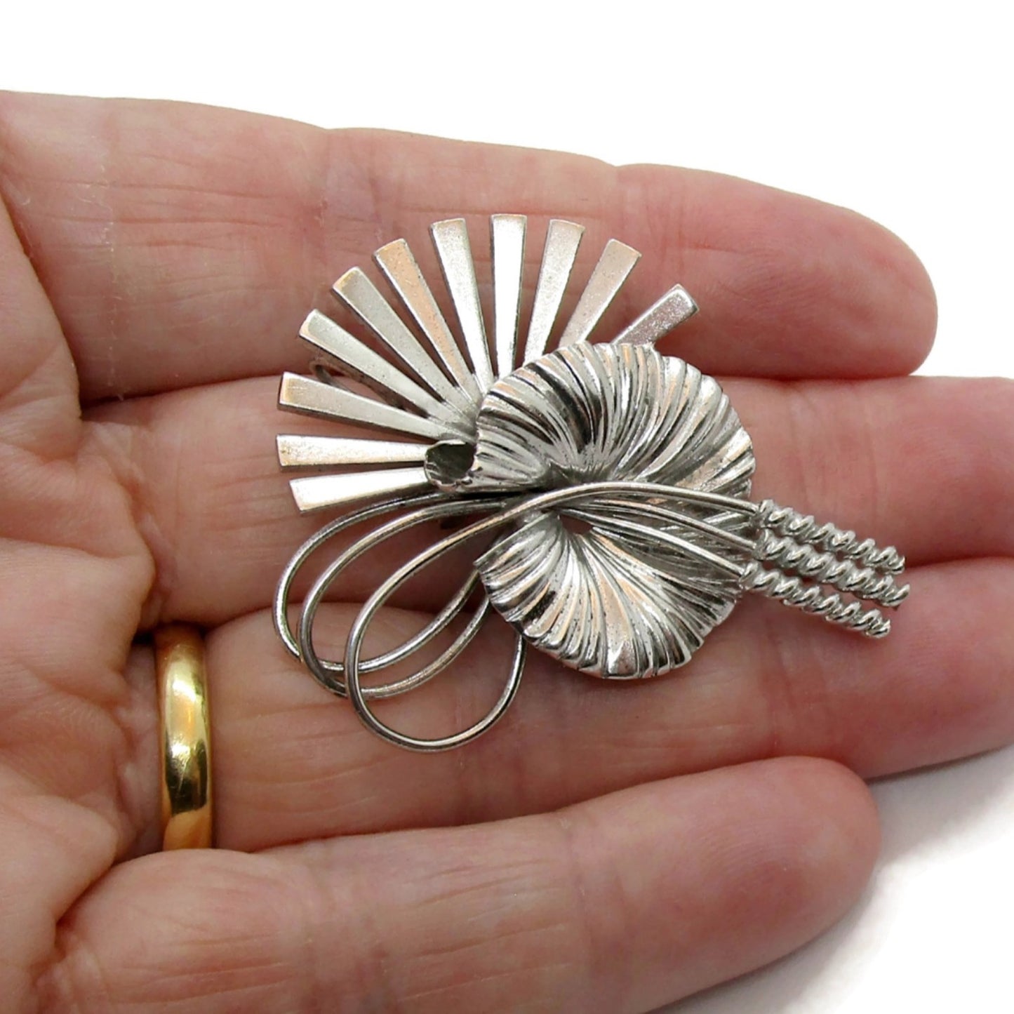 Vintage sterling silver Carl Art USA brooch shown held in hand