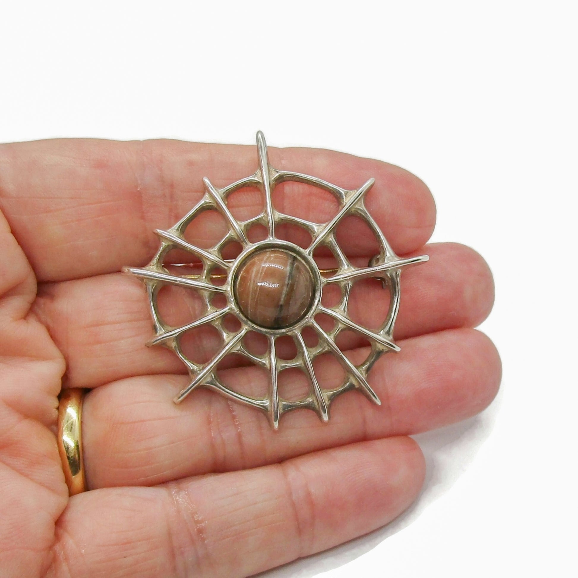 David Andersen sterling silver and thulite Troll series spiderweb brooch shown held in a hand