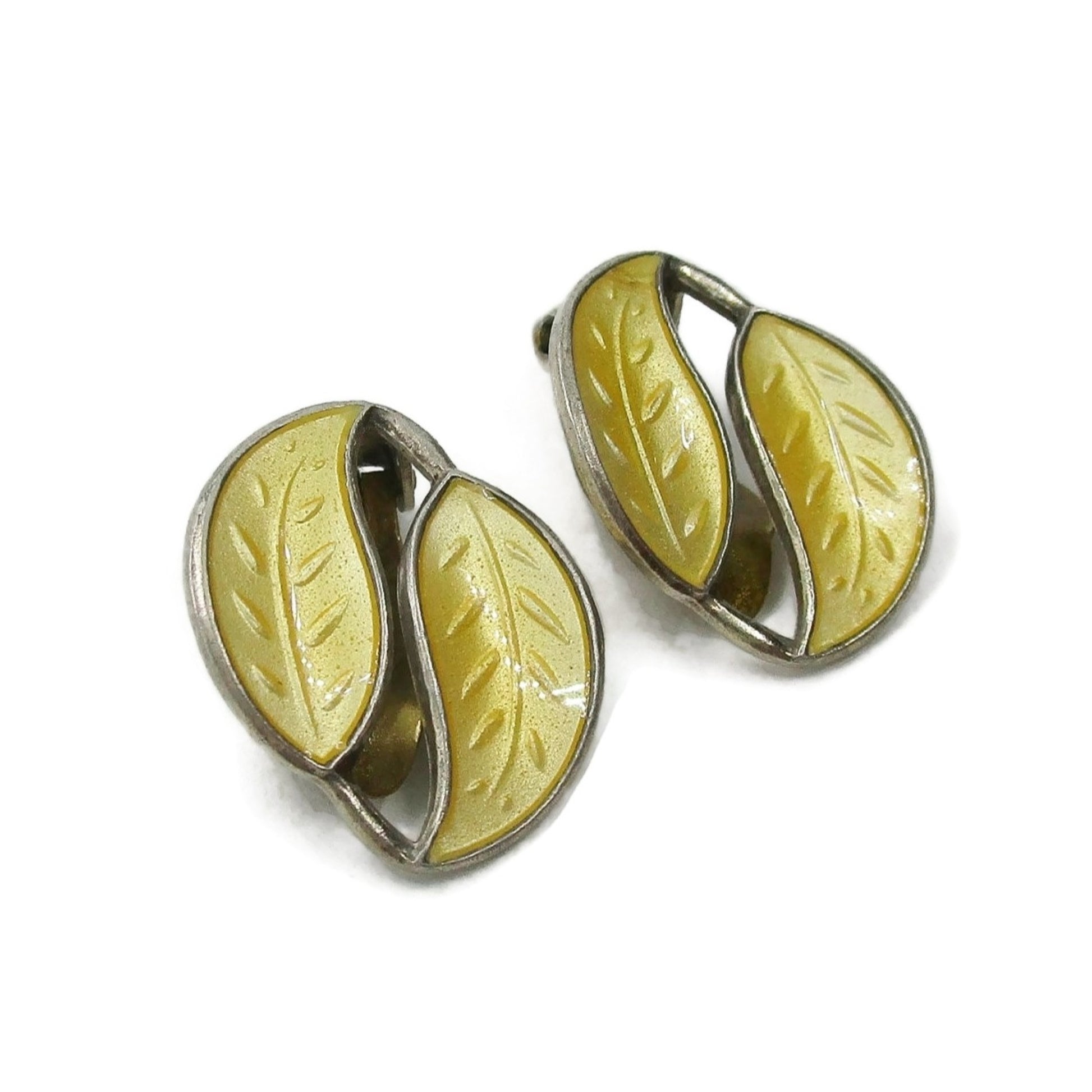 Angled view of a pair of David Andersen Norway small yellow enamel double leaf clip on earrings