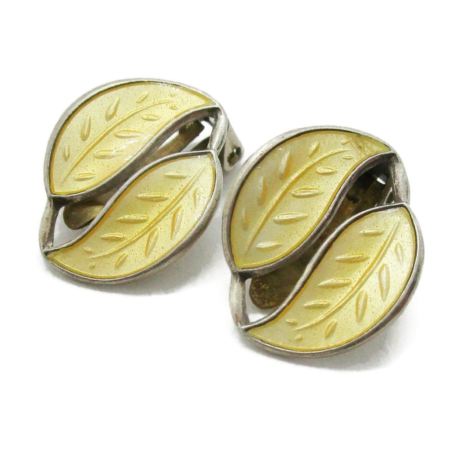 A pair of David Andersen Norway small yellow enamel double leaf clip on earrings shown close up on an angle