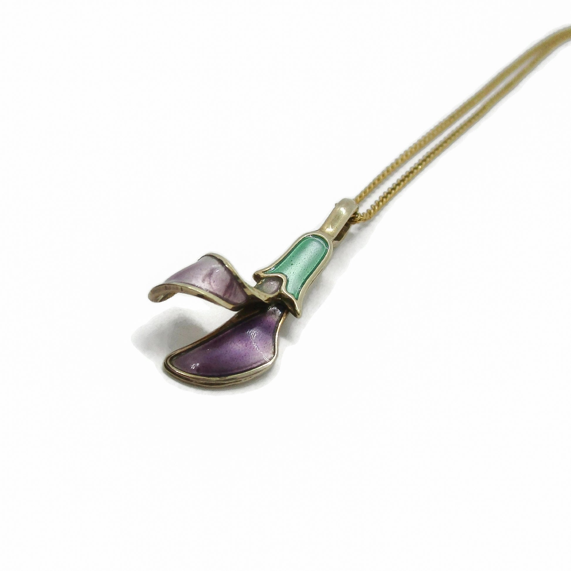 Angled view of a purple and green enamel flower pendant by David Andersen Norway