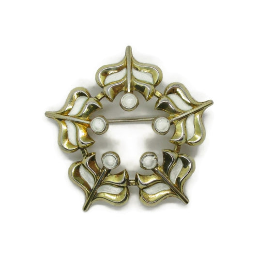 Front view of a David Andersen sterling silver gilt and enamel snowflake brooch
