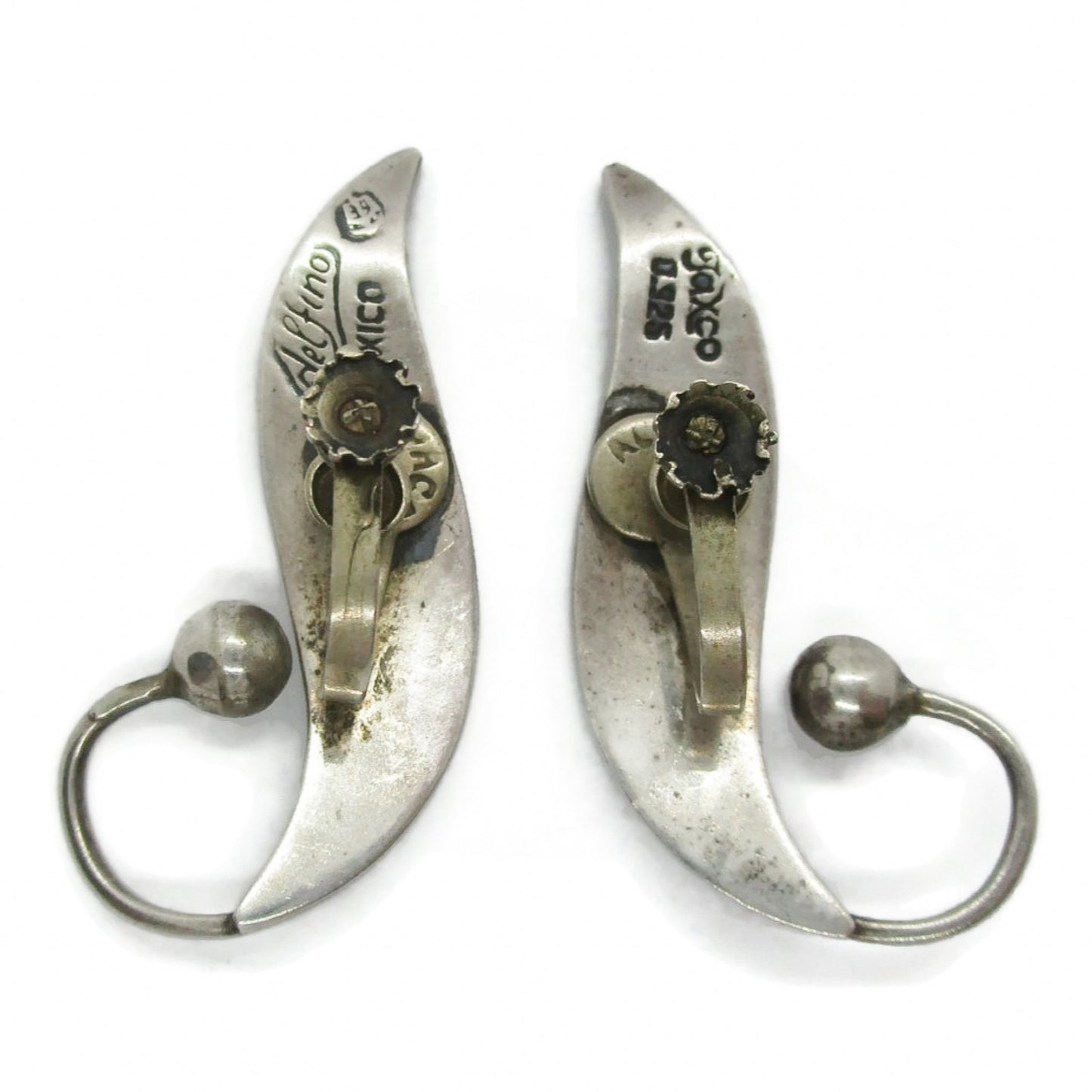 Back view of a pair of sterling silver screw on earrings in a curvy design by Delfino Mexico showing hallmarks