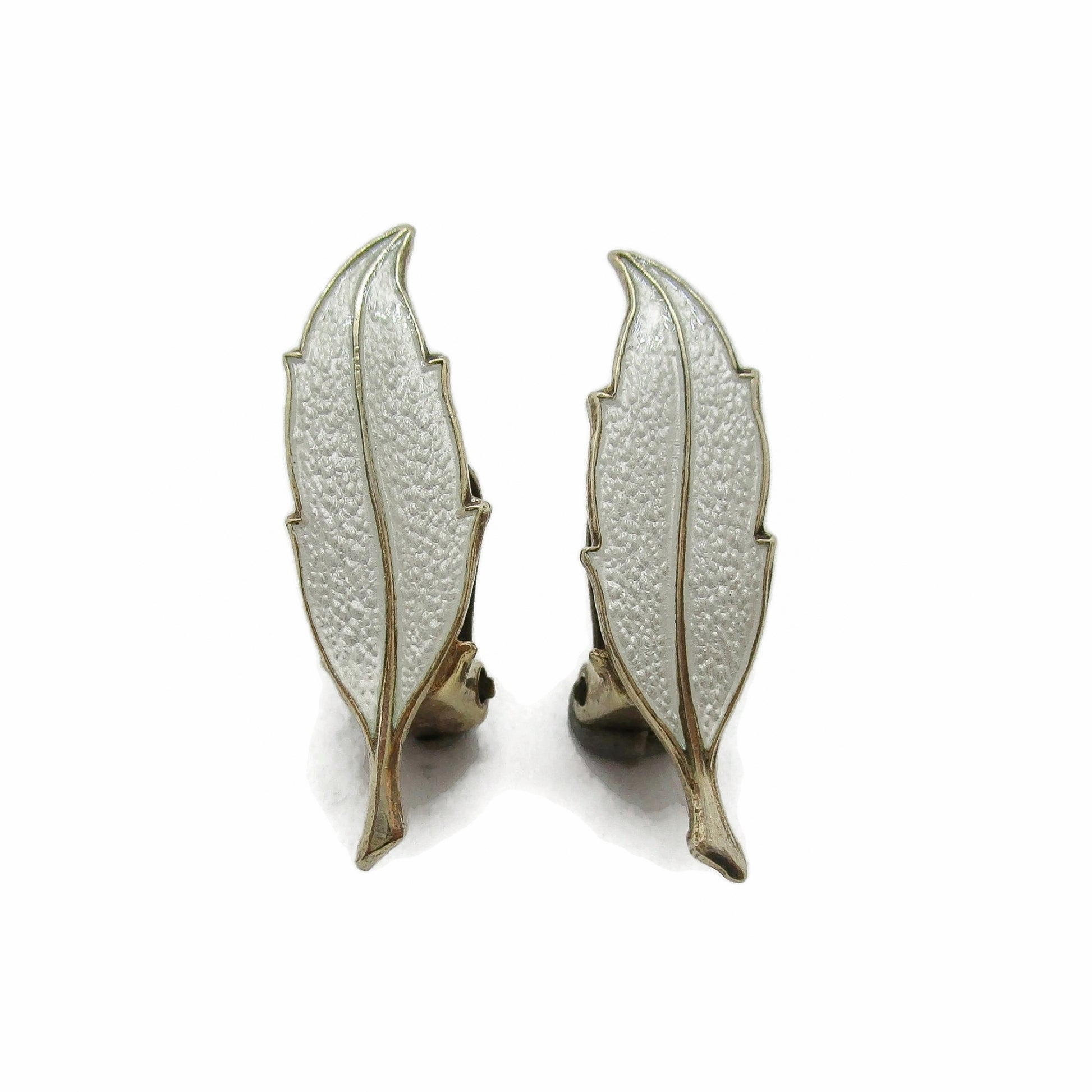 Front view of a pair of Finn Jensen Norway sterling silver gilt and white enamel leaf clip on earrings