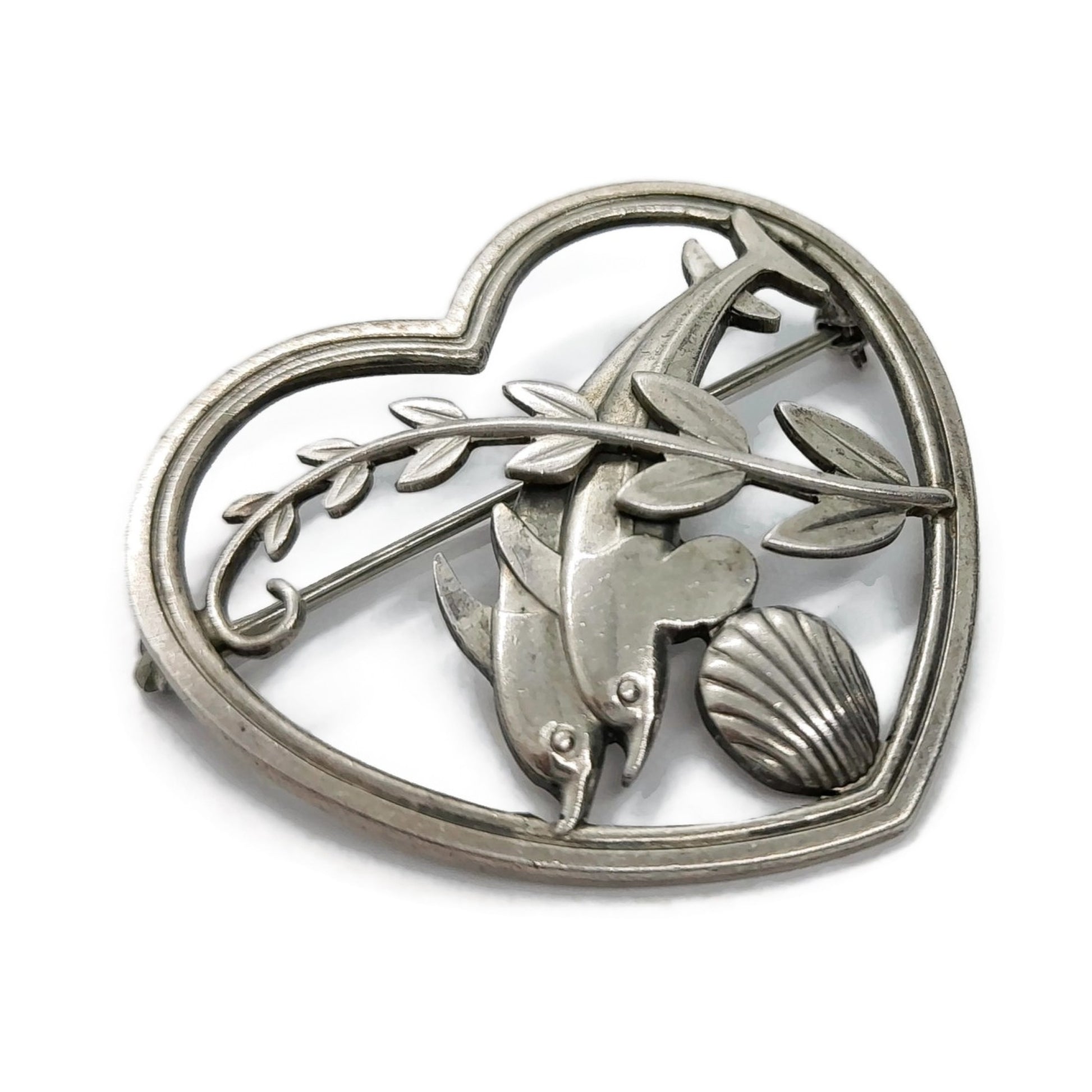 Angled view of Georg Jensen sterling silver dolphins in a heart brooch number 312