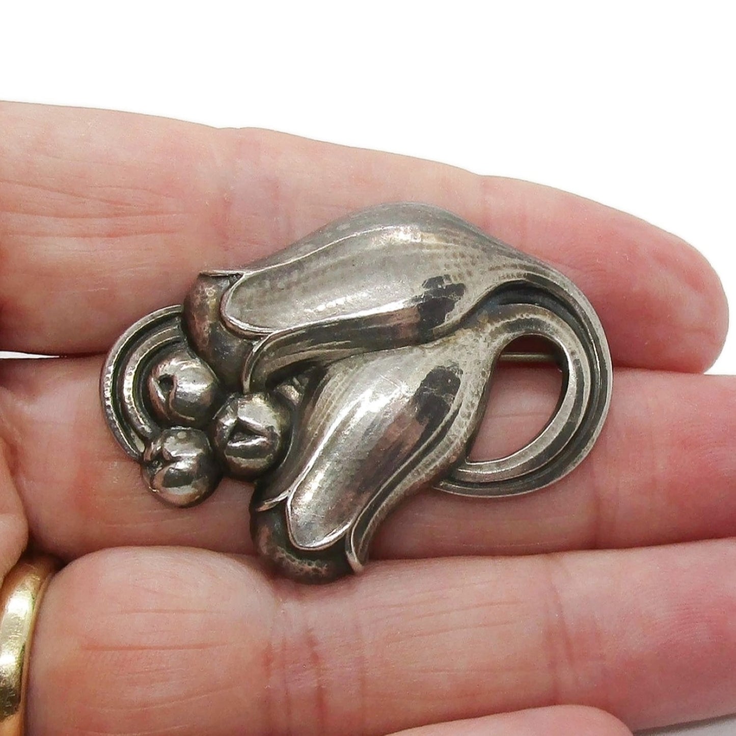 Georg jensen sterling silver tulip brooch number 100B shown held in a hand