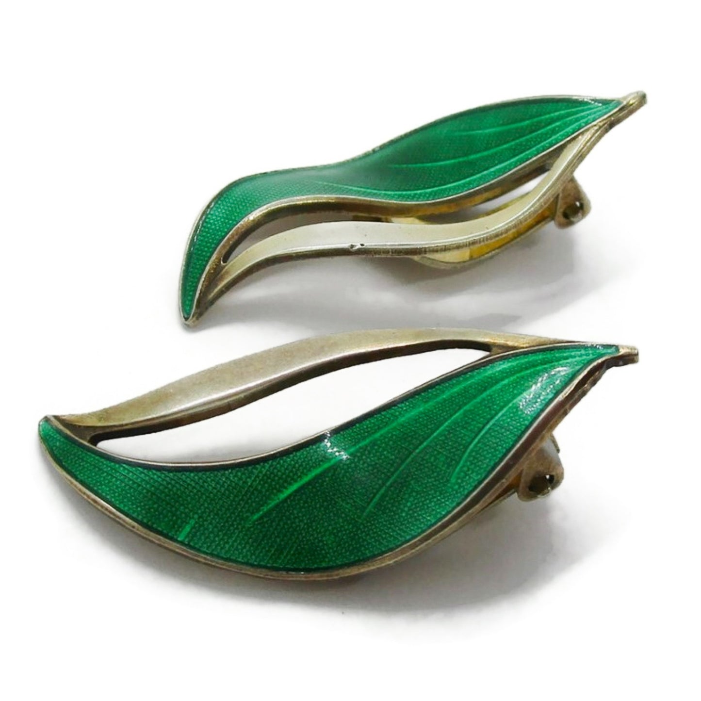 A pair of Hroar Prydz Norway green enamel and sterling silver gilt leaf shaped clip on earrings seen from the side