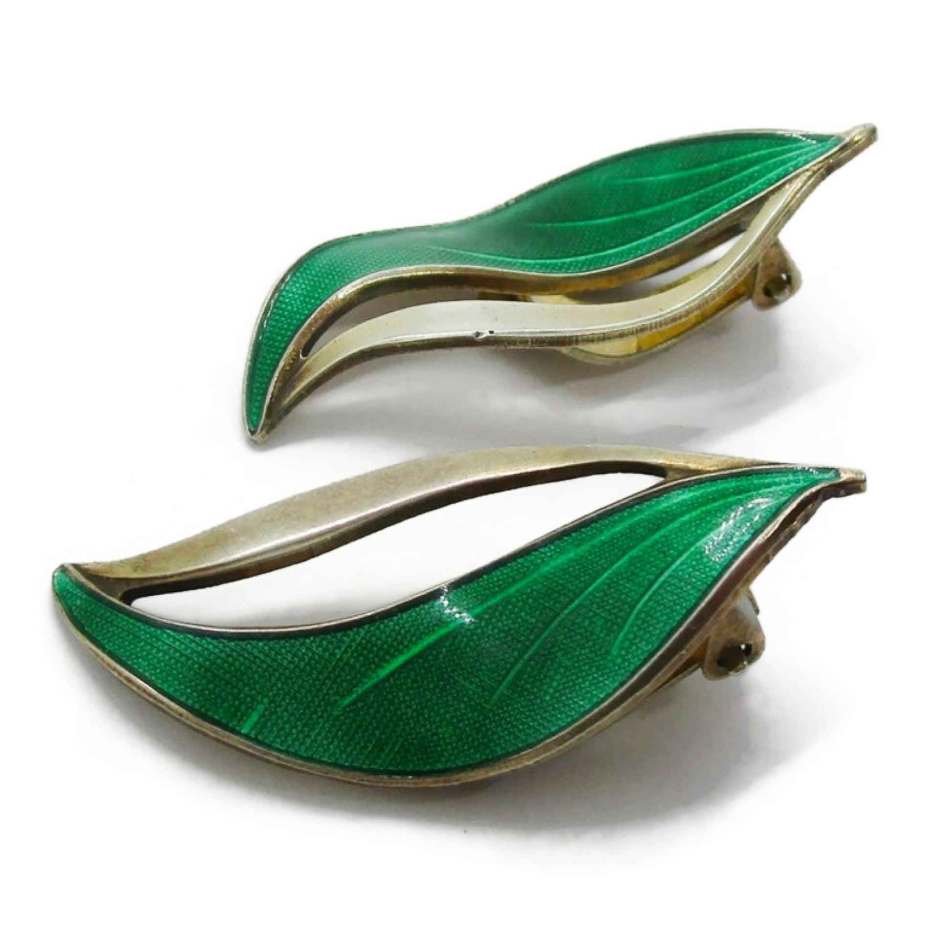 A pair of Hroar Prydz Norway green enamel and sterling silver gilt leaf shaped clip on earrings seen from the side