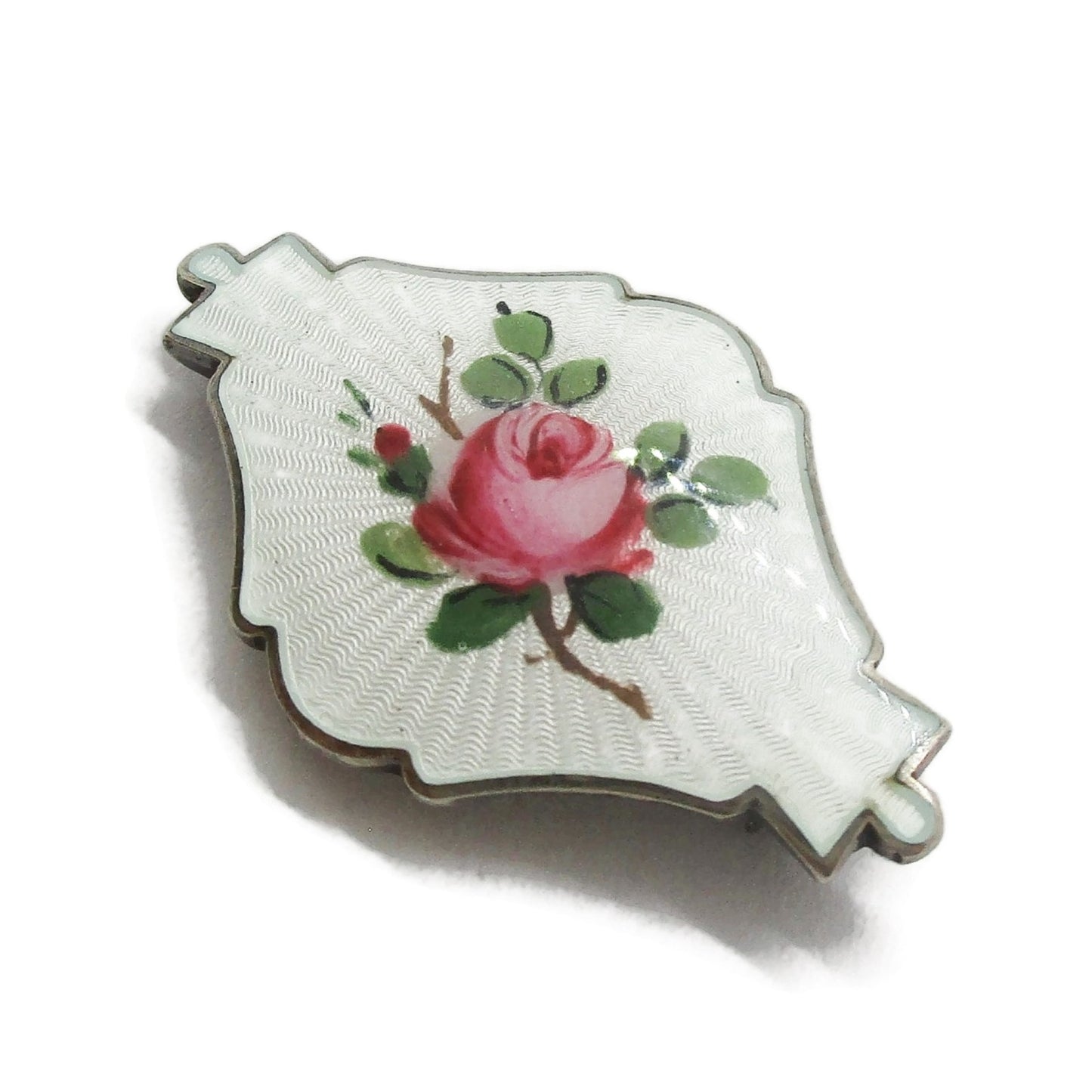 Side view of small shield shaped Ivar Holth Norway sterling silver enamel pink rose brooch