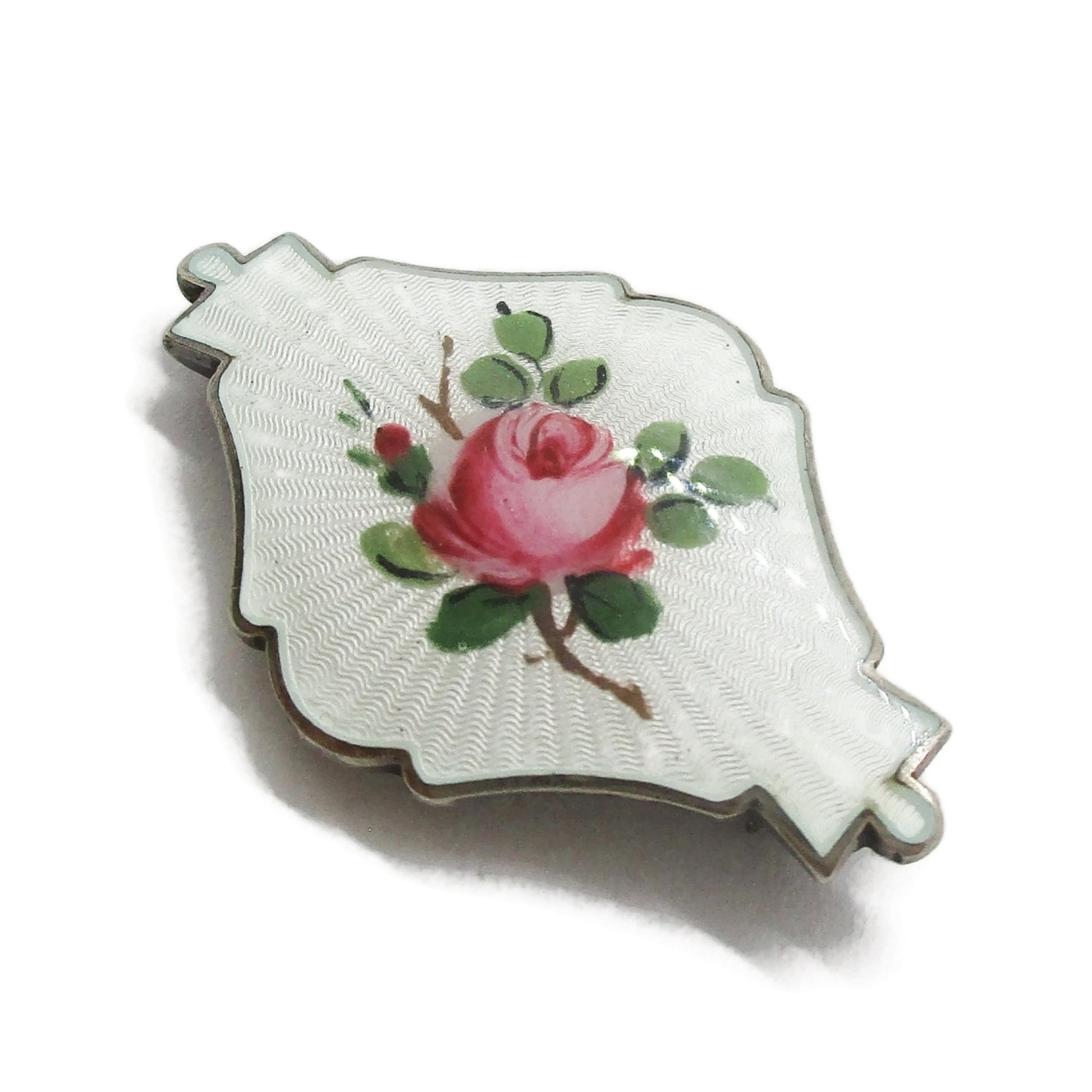 Side view of small shield shaped Ivar Holth Norway sterling silver enamel pink rose brooch
