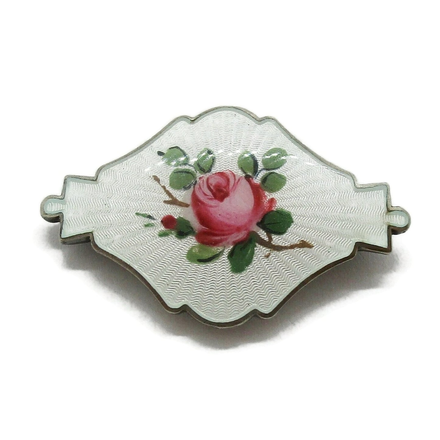Front view of small shield shaped Ivar Holth Norway sterling silver enamel pink rose brooch
