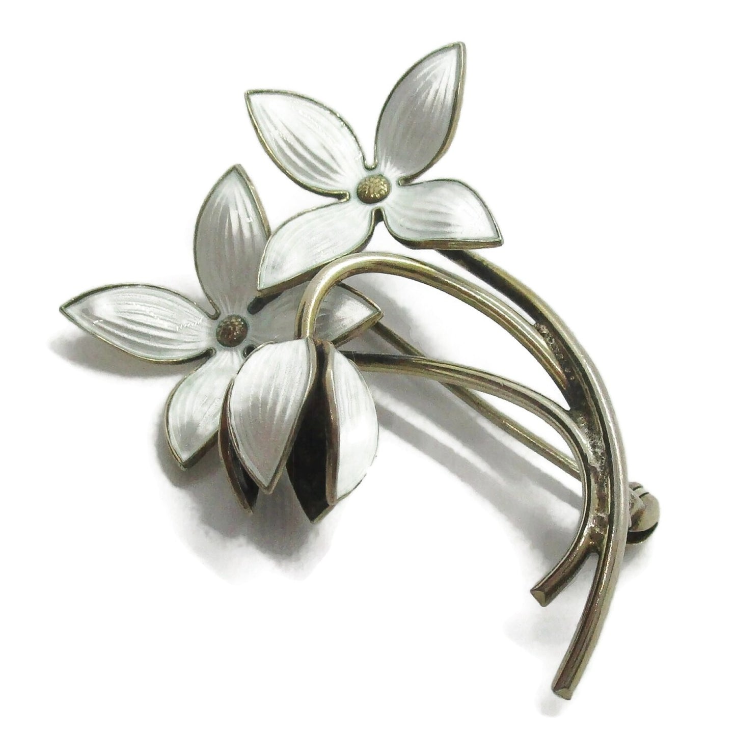 Close up view of an Ivar Holth Norway sterling silver gilt and white enamel flower spray brooch