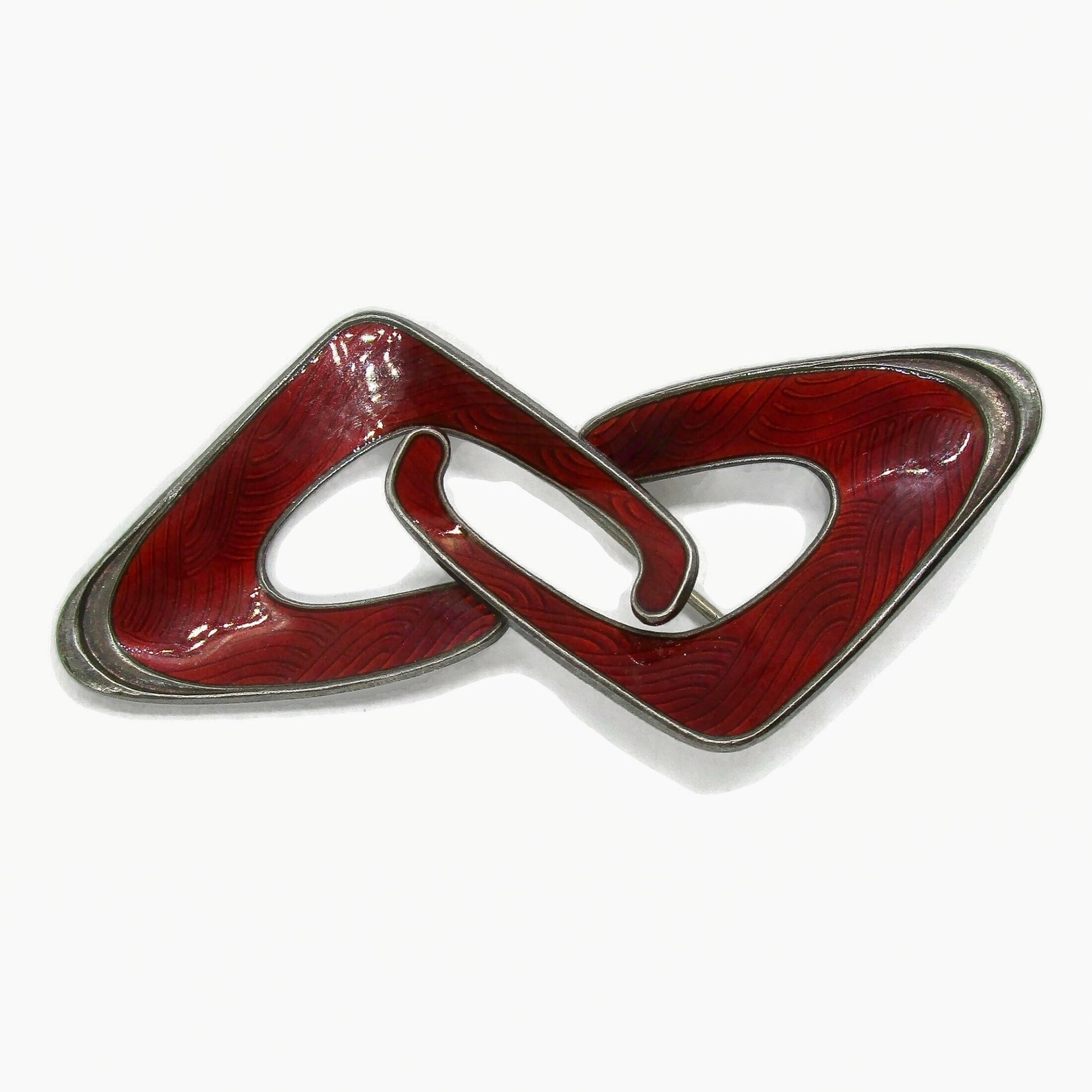Front view of an Ivar Holth Norway red enamel and sterling silver abstract brooch