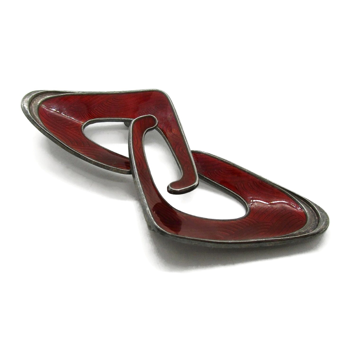 Angled view of an Ivar Holth Norway red enamel and sterling silver abstract brooch