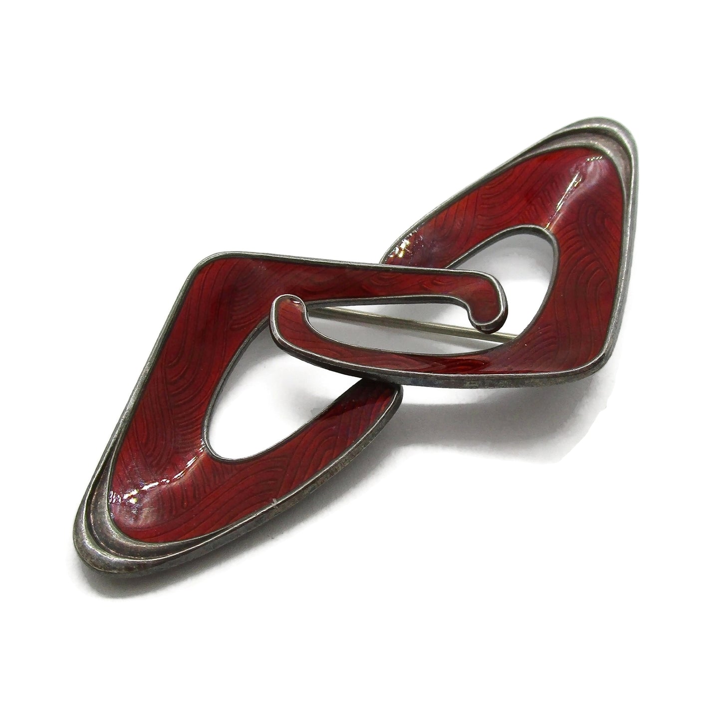 Close up view of an Ivar Holth Norway red enamel and sterling silver abstract brooch