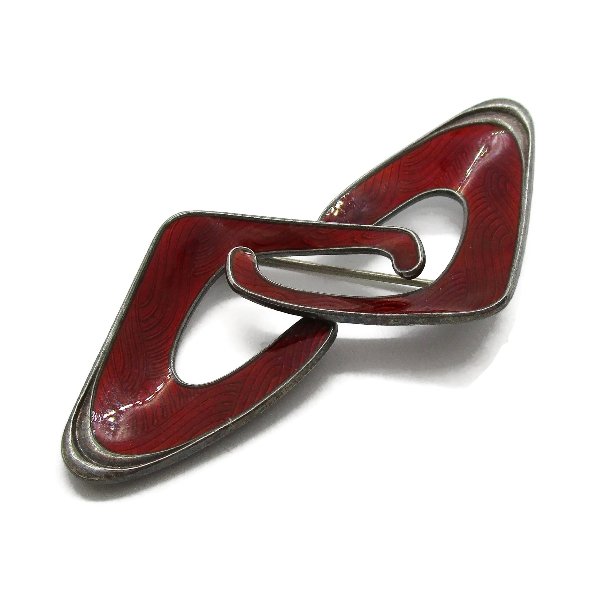 Close up view of an Ivar Holth Norway red enamel and sterling silver abstract brooch