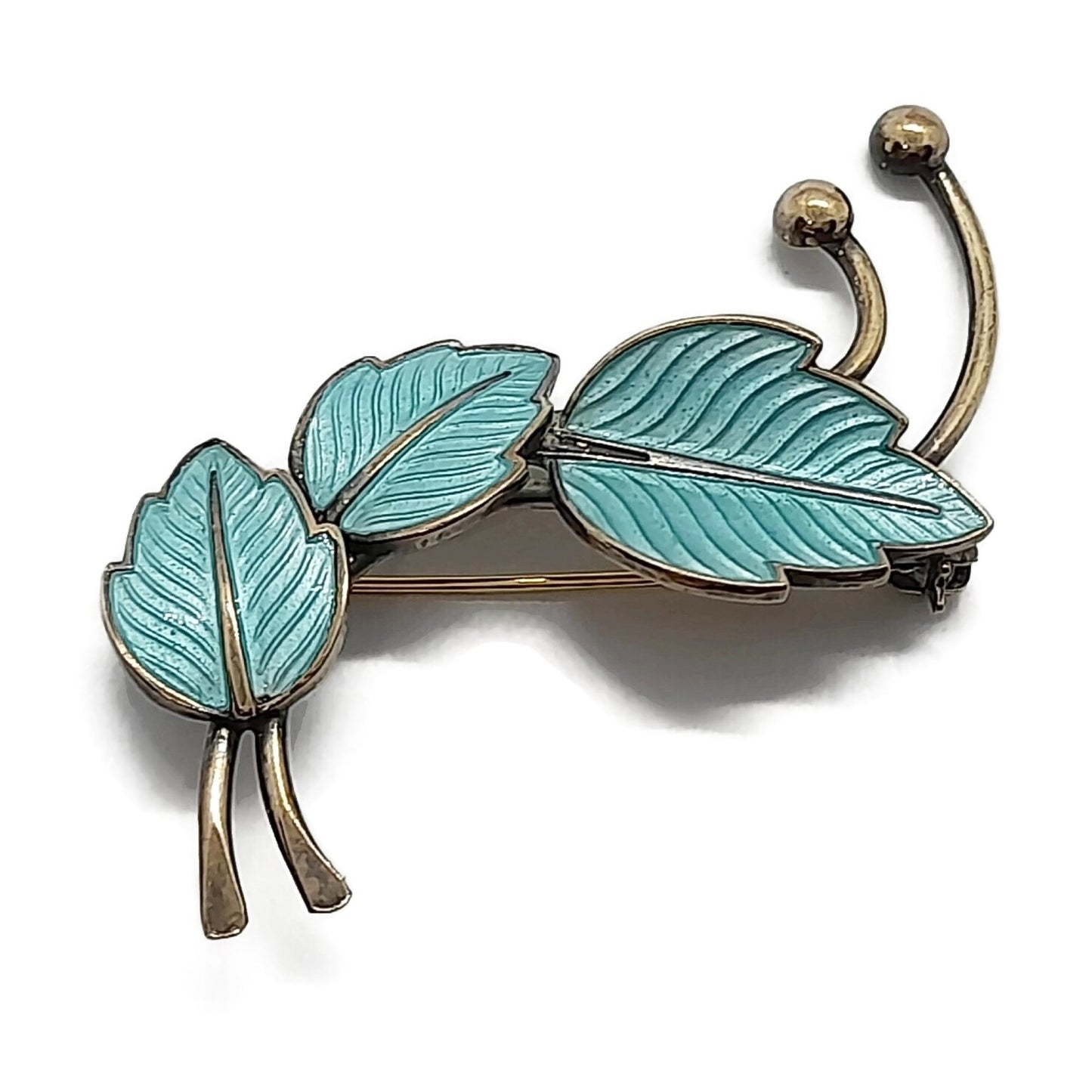Front view of Jemax Denmark blue guilloche enamel and sterling silver gilt leaves brooch