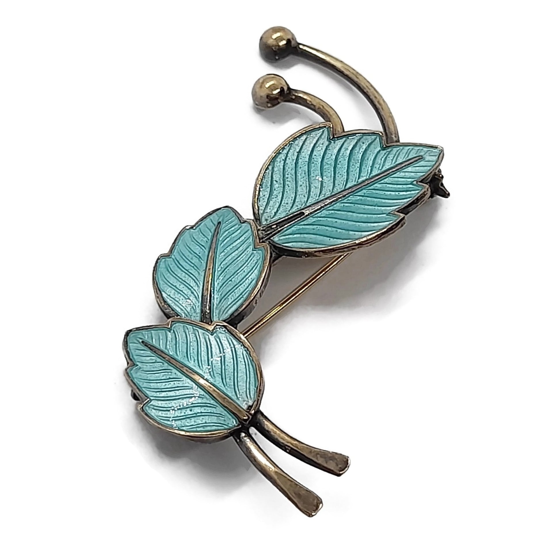 Jemax Denmark turquoise enamel and sterling silver gilt leaf brooch shown on its side