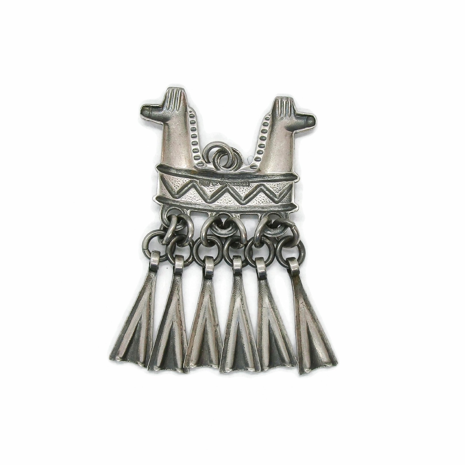 Back view of a Kalevala Koru Finland sterling silver double headed horse pendant