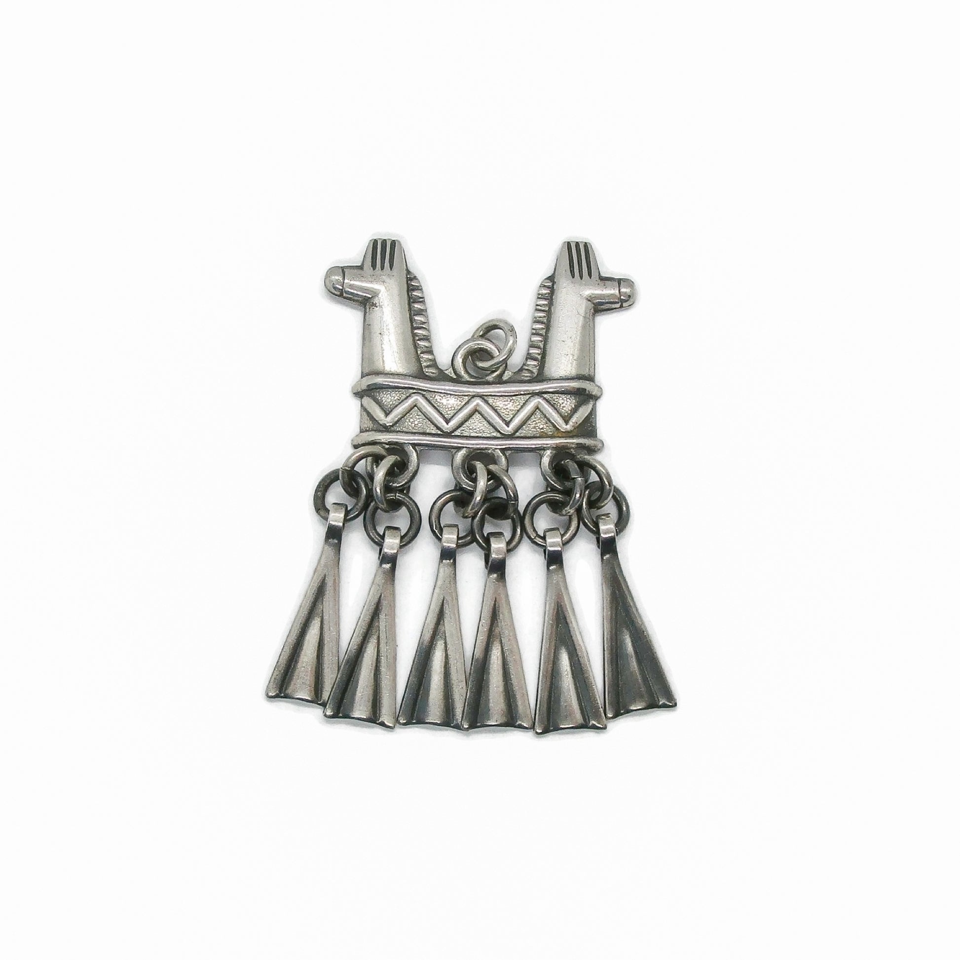Front view of a Kalevala Koru Finland sterling silver double headed horse pendant