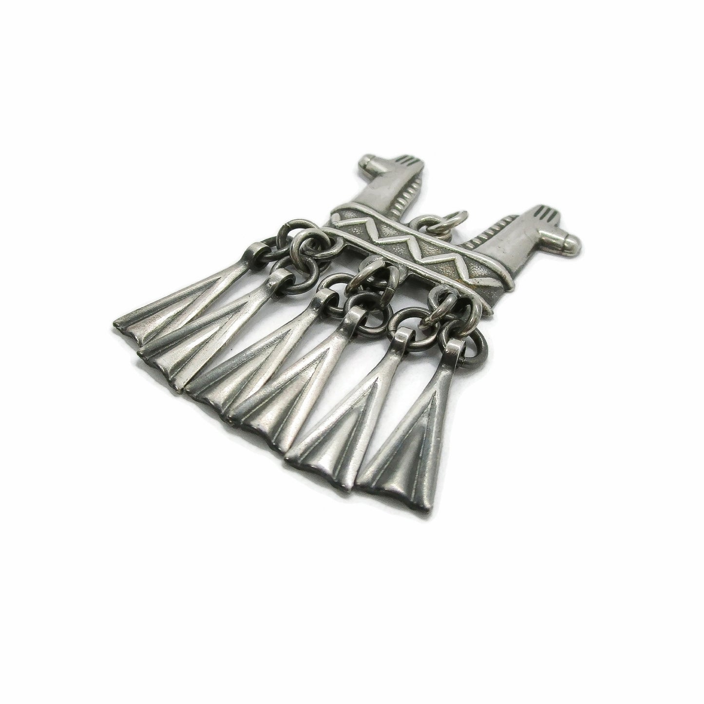 Side view of a Kalevala Koru Finland sterling silver double headed horse pendant