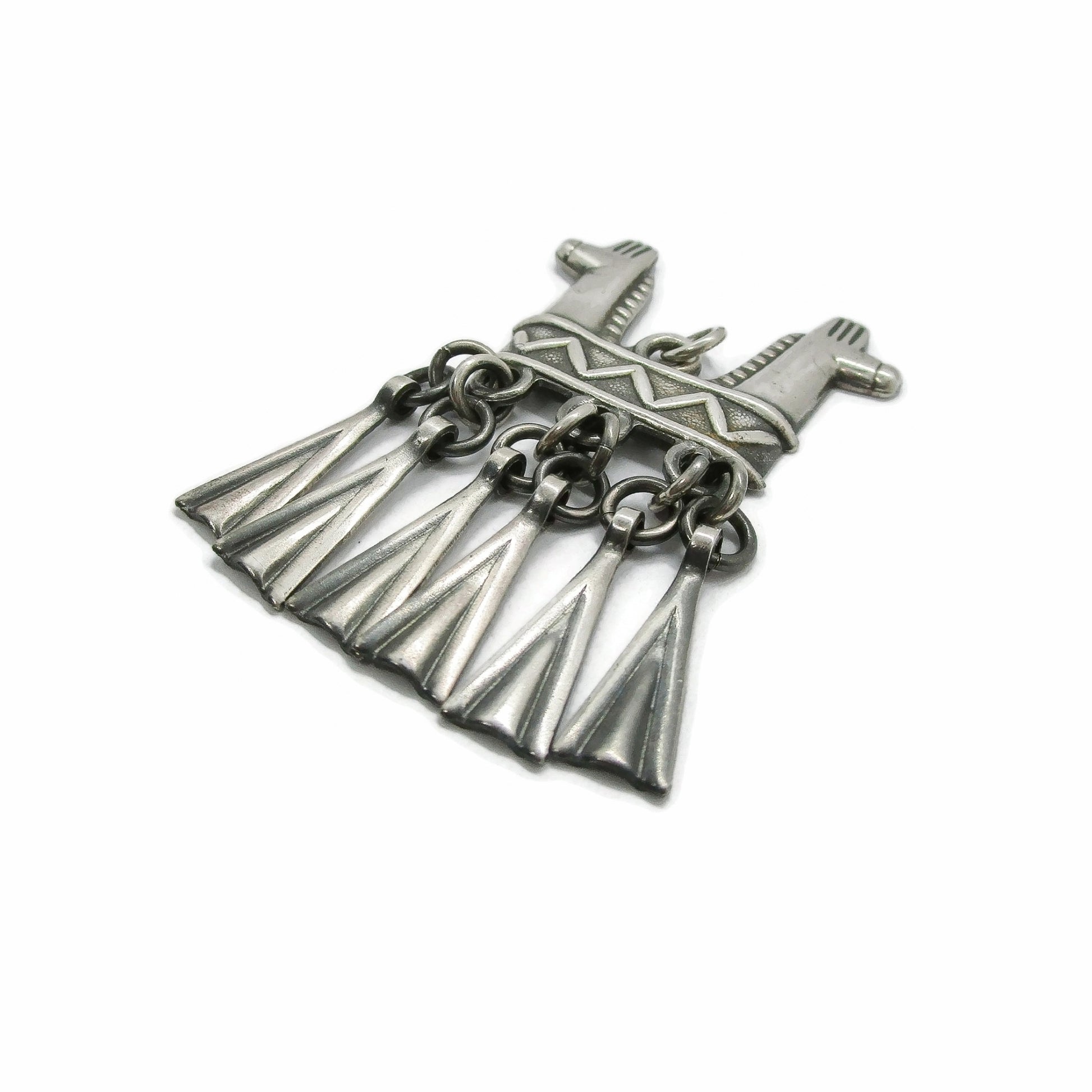 Side view of a Kalevala Koru Finland sterling silver double headed horse pendant