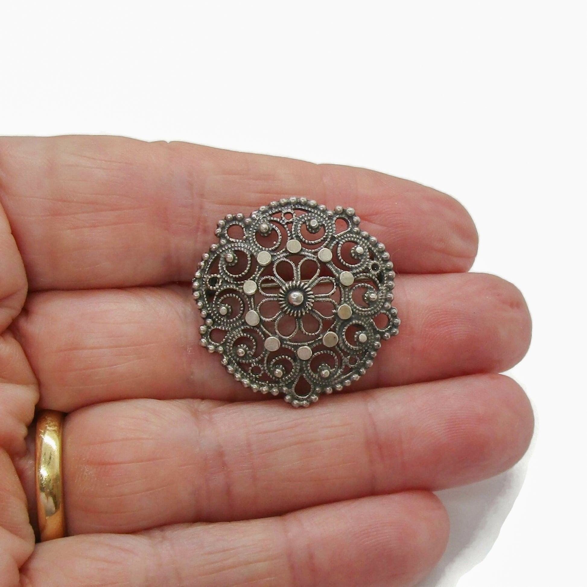 Small Knut Paulsen Norway sterling silver brooch shown held in a hand