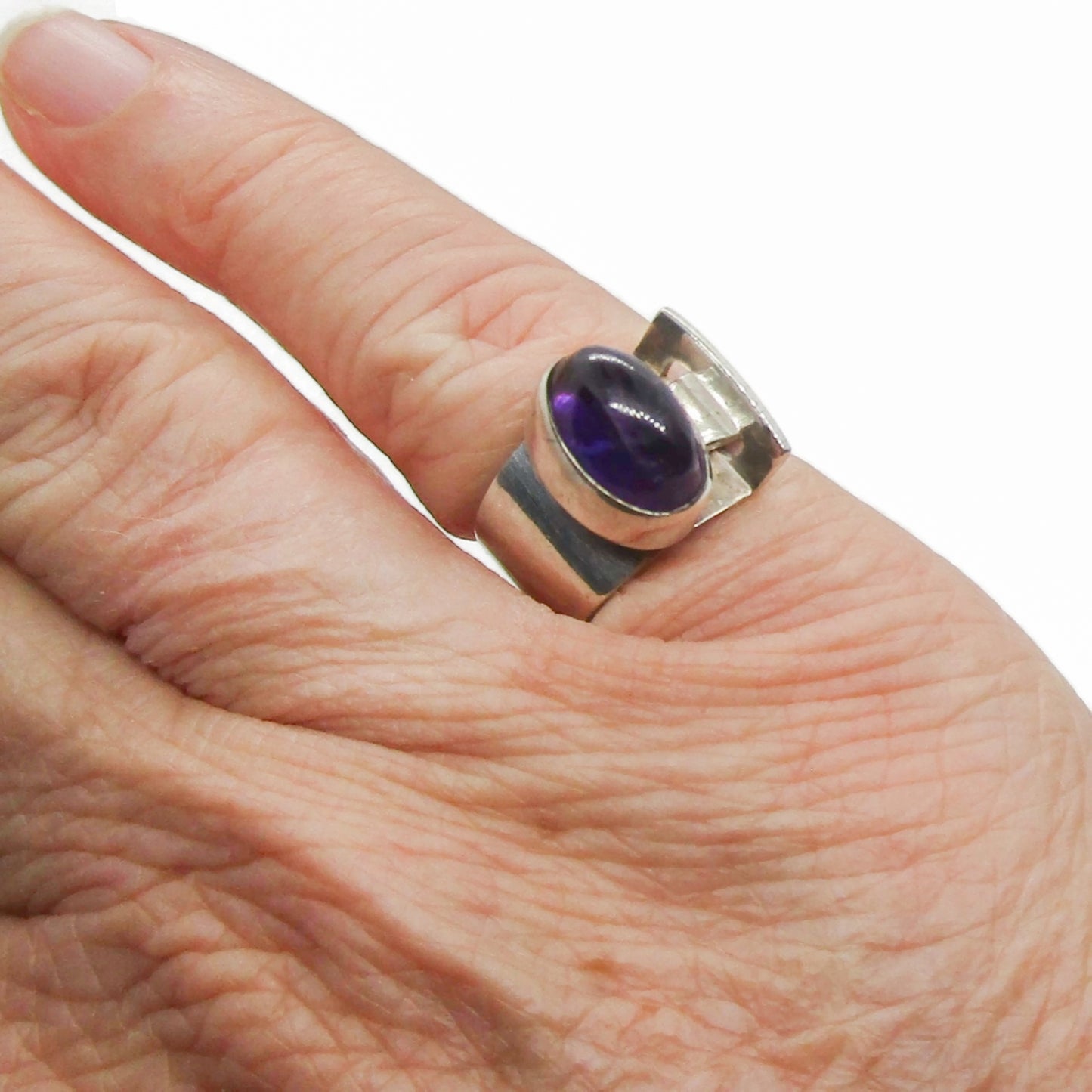 A sterling silver and amethyst ring by Kupittaan Kulta Finland shown worn on a hand