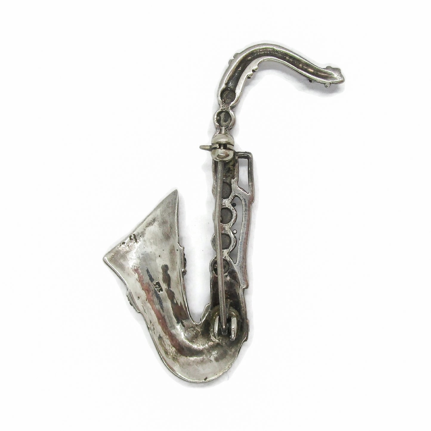 Back view of a vintage sterling silver and marcasite saxophone brooch