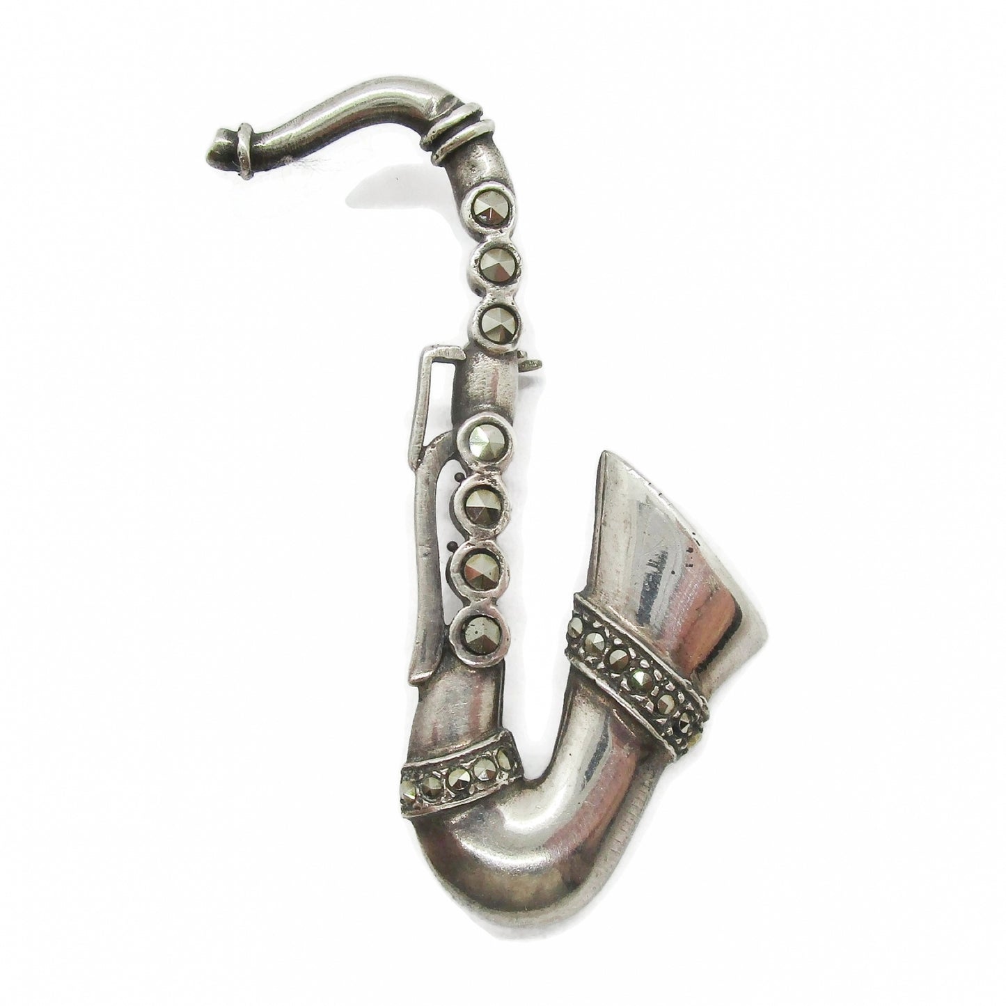 Front view of a vintage sterling silver and marcasite saxophone brooch