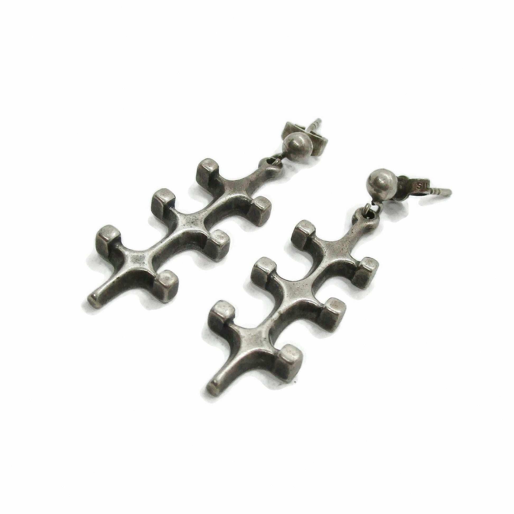 A pair of Marianne Berg Troll series sterling silver dangle earrings seen from the side