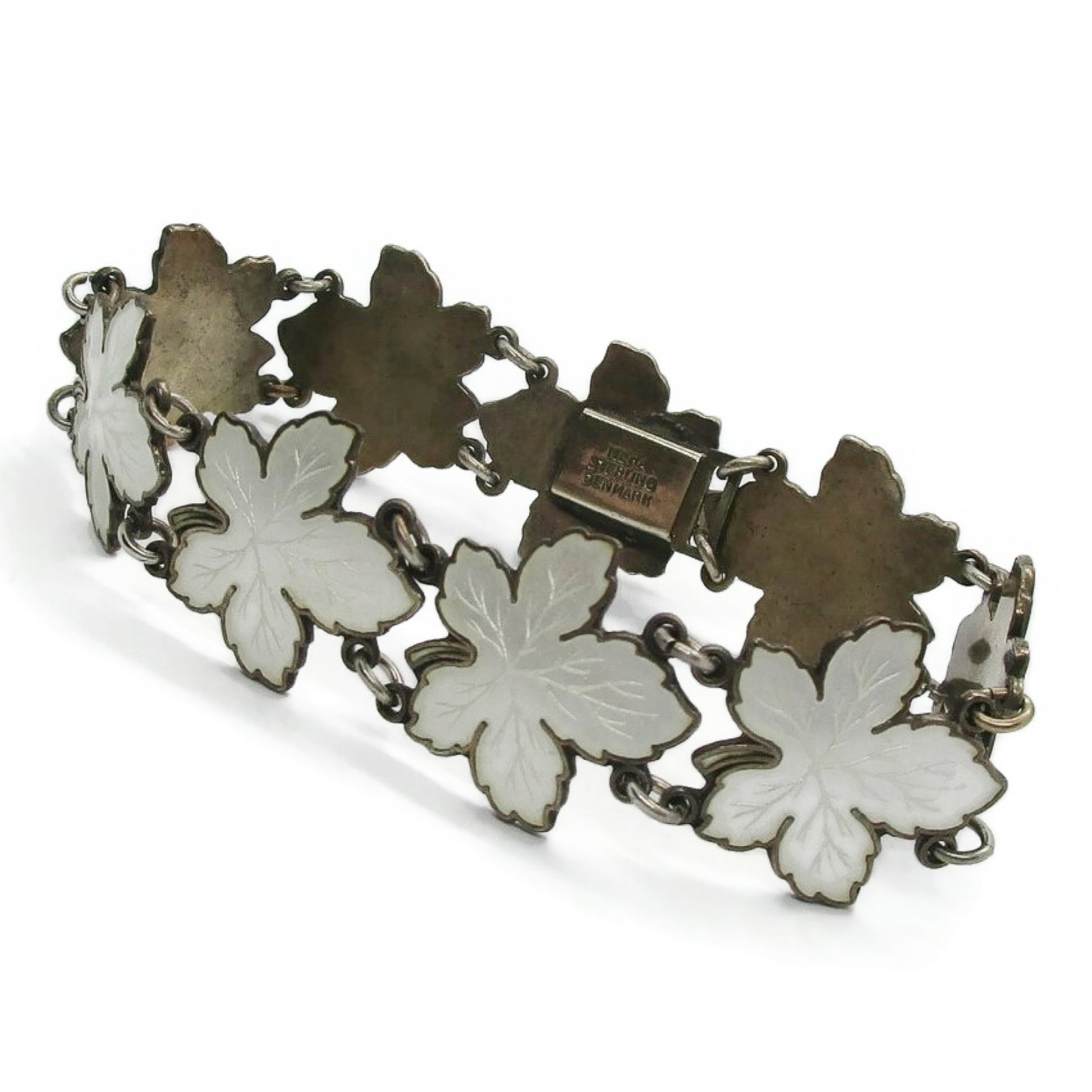 Meka sterling silver and white enamel maple leaf bracelet shown done up and on an angle