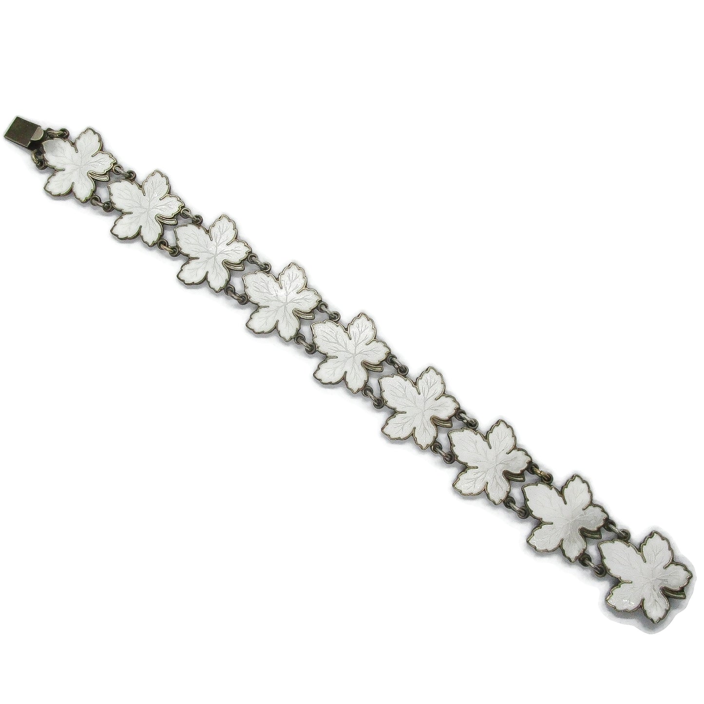 Meka sterling silver and white enamel maple leaf bracelet laid flat