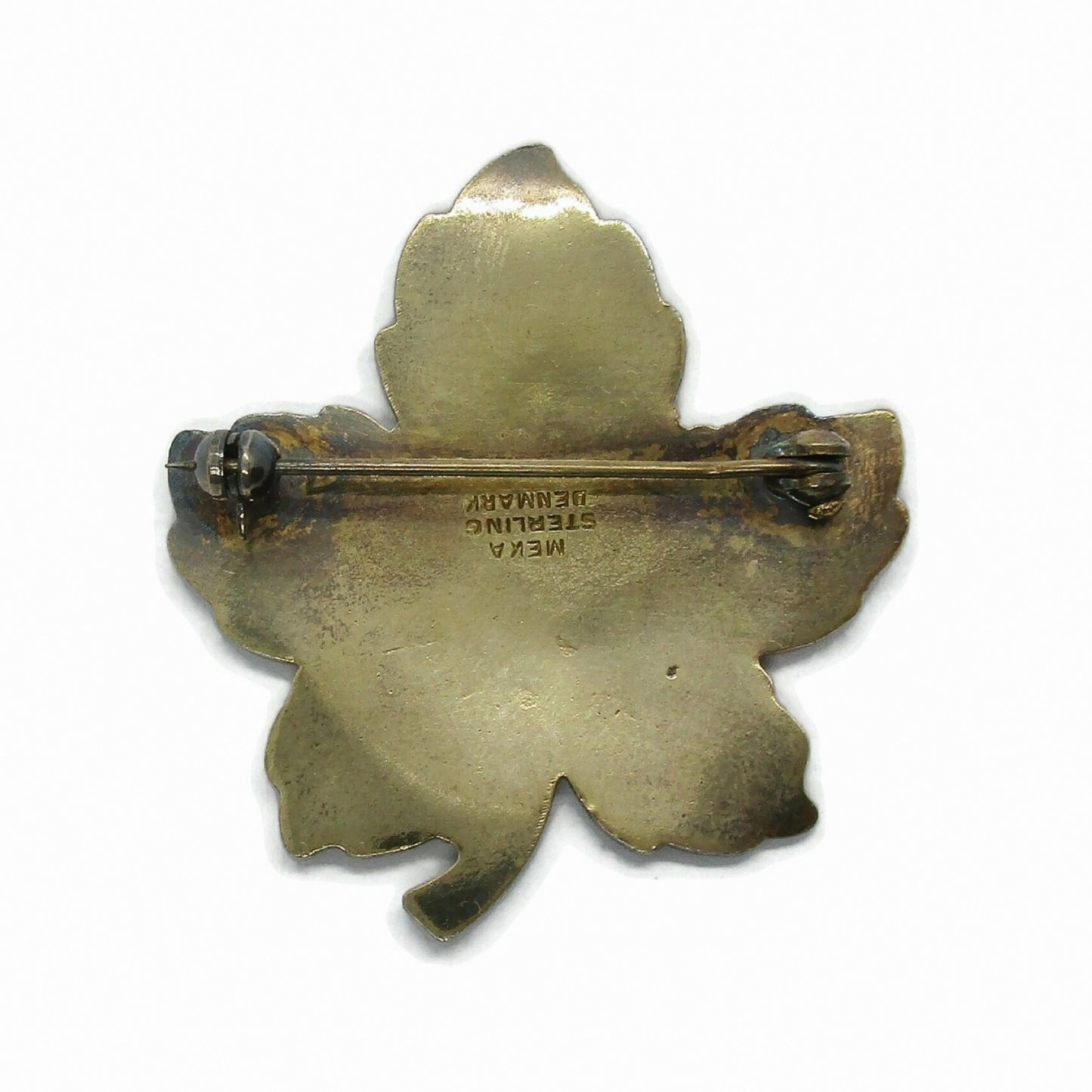 Back view of Meka Denmark sterling silver gilt and yellow enamel maple leaf brooch showing hallmarks