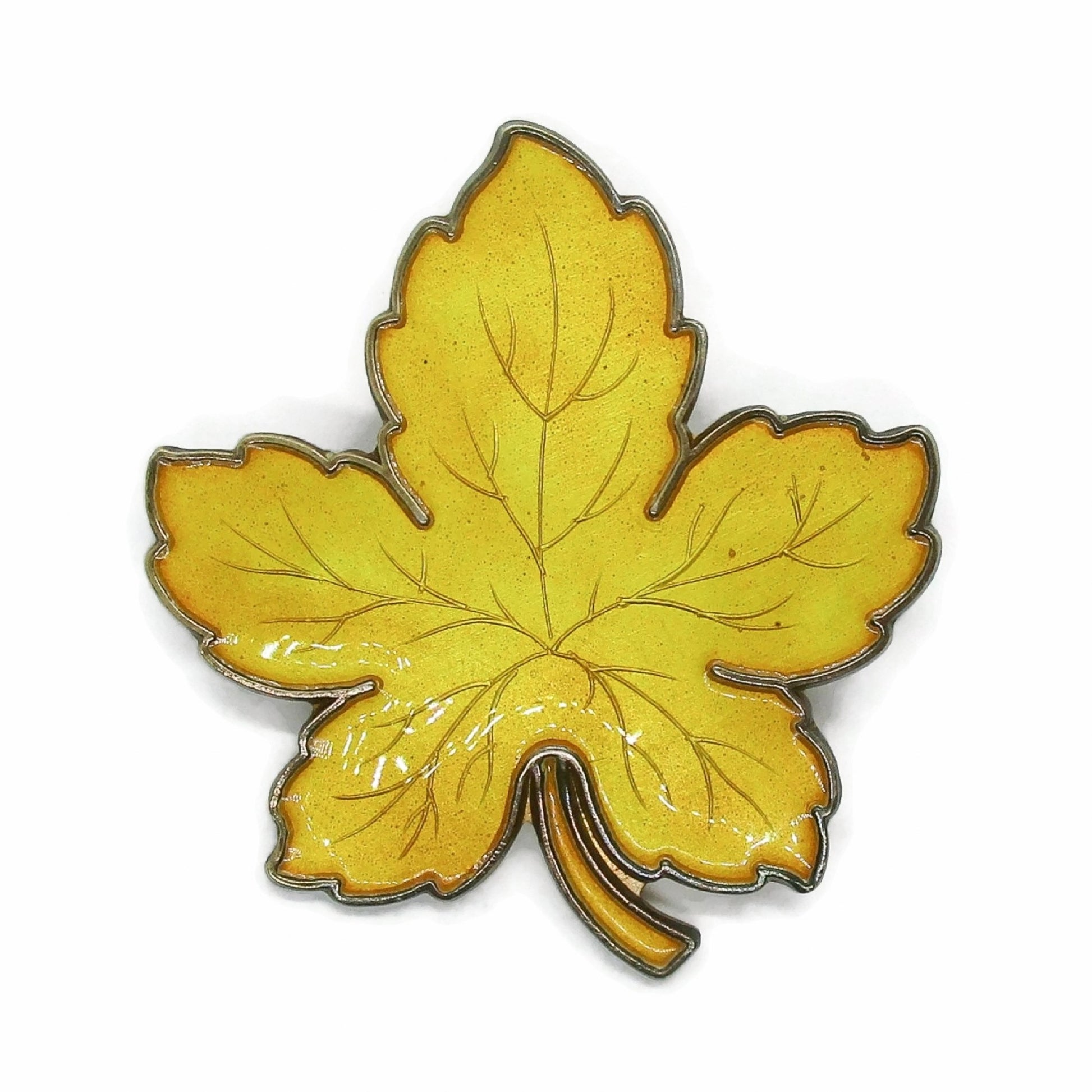 Front view of Meka Denmark sterling silver and yellow enamel maple leaf brooch