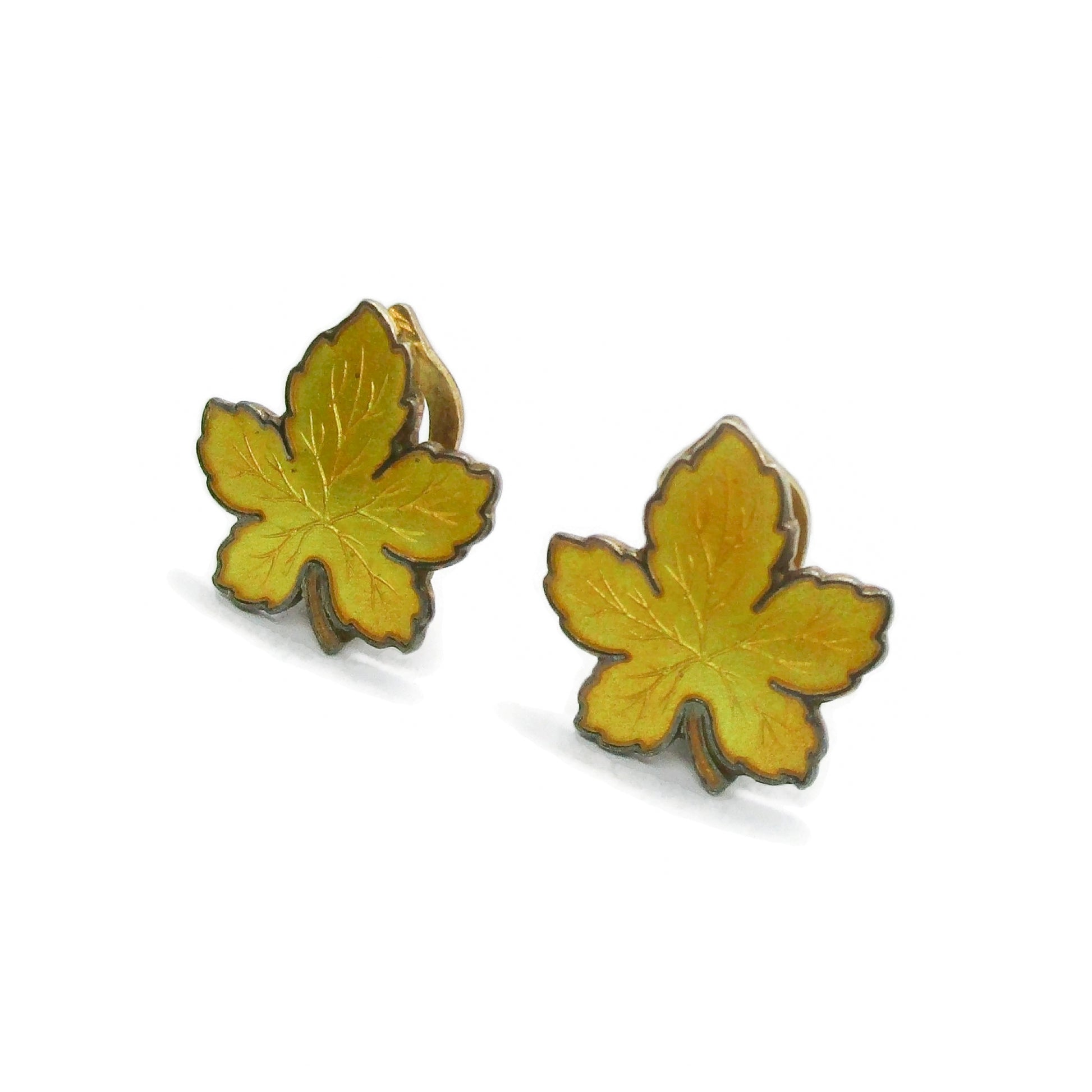 Side view of a pair of Meka Denmark yellow guilloche enamel and sterling silver gilt maple leaf clip on earrings