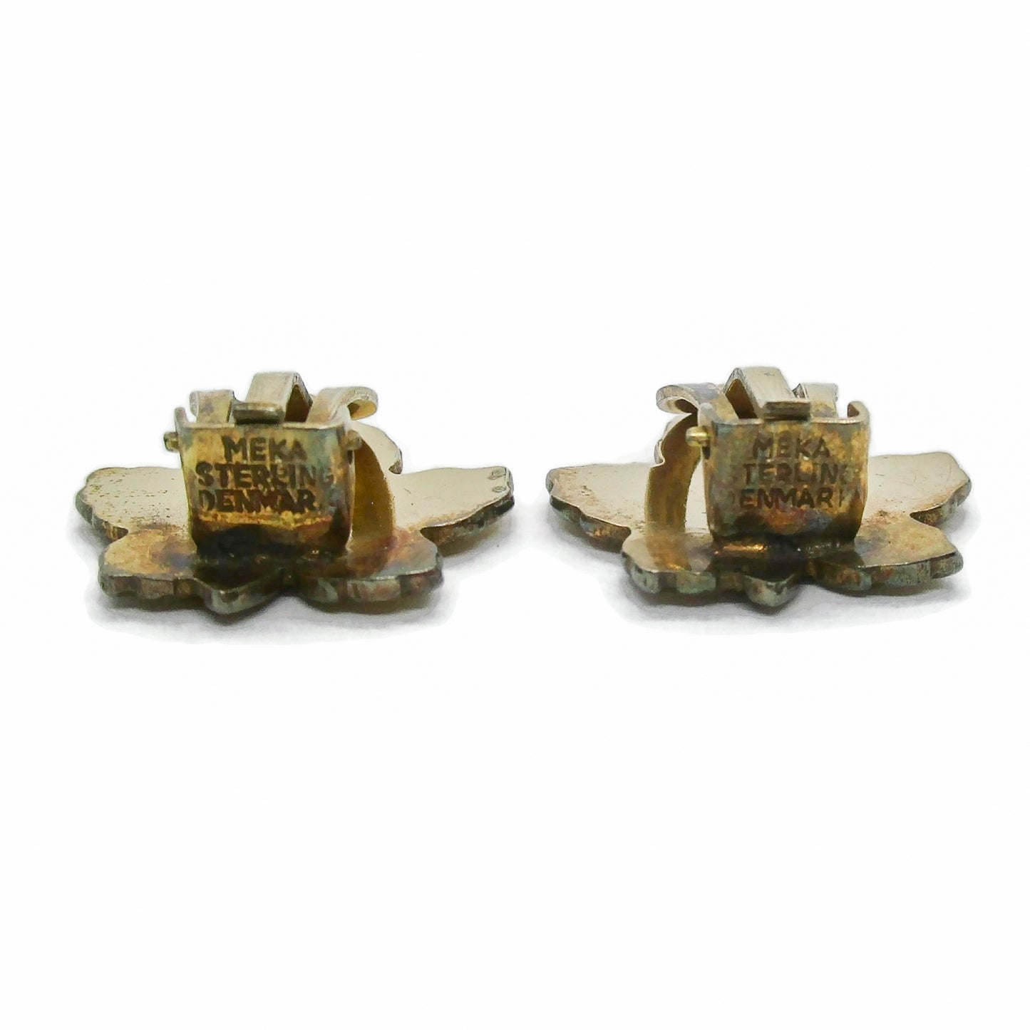 A pair of Meka Denmark yellow guilloche enamel and sterling silver gilt maple leaf clip on earrings seen from the bottom showing hallmarks
