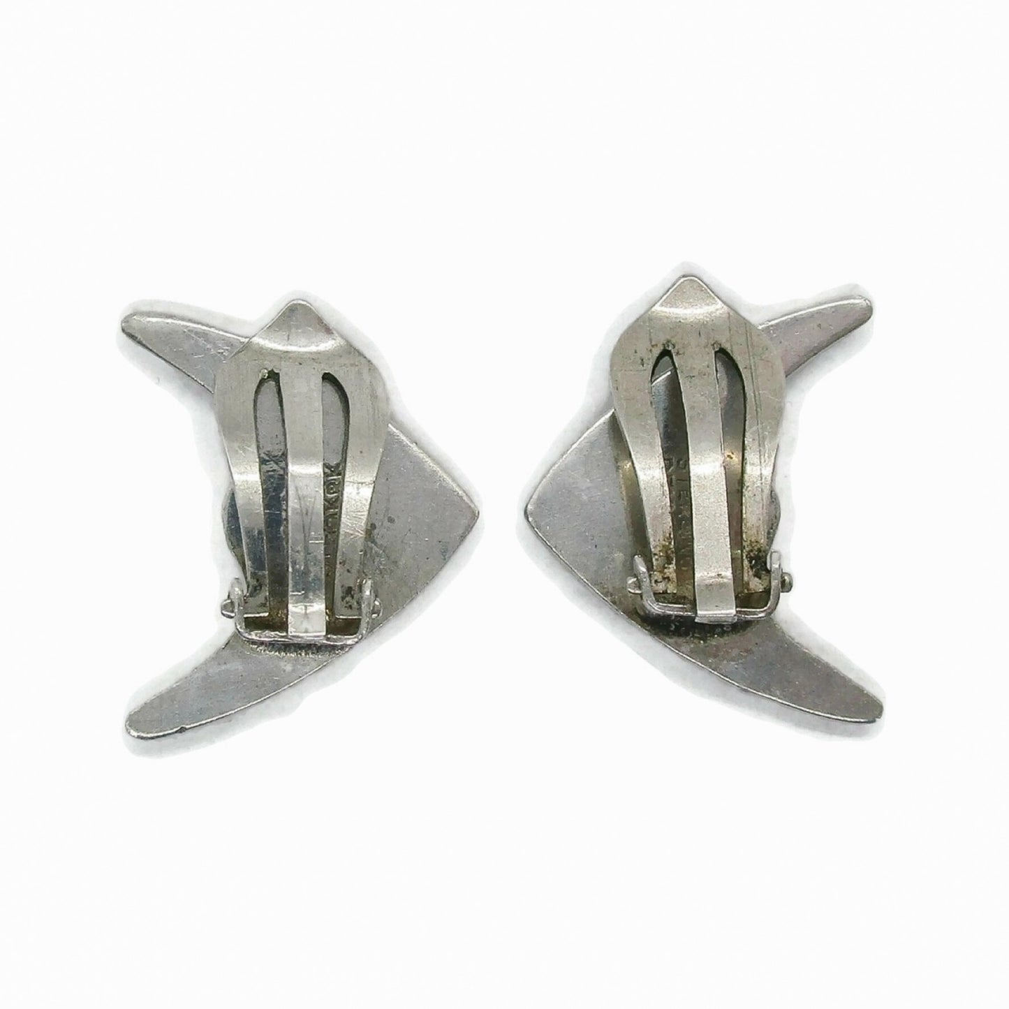 Back view of a pair of Meka sterling silver striped fish clip on earrings