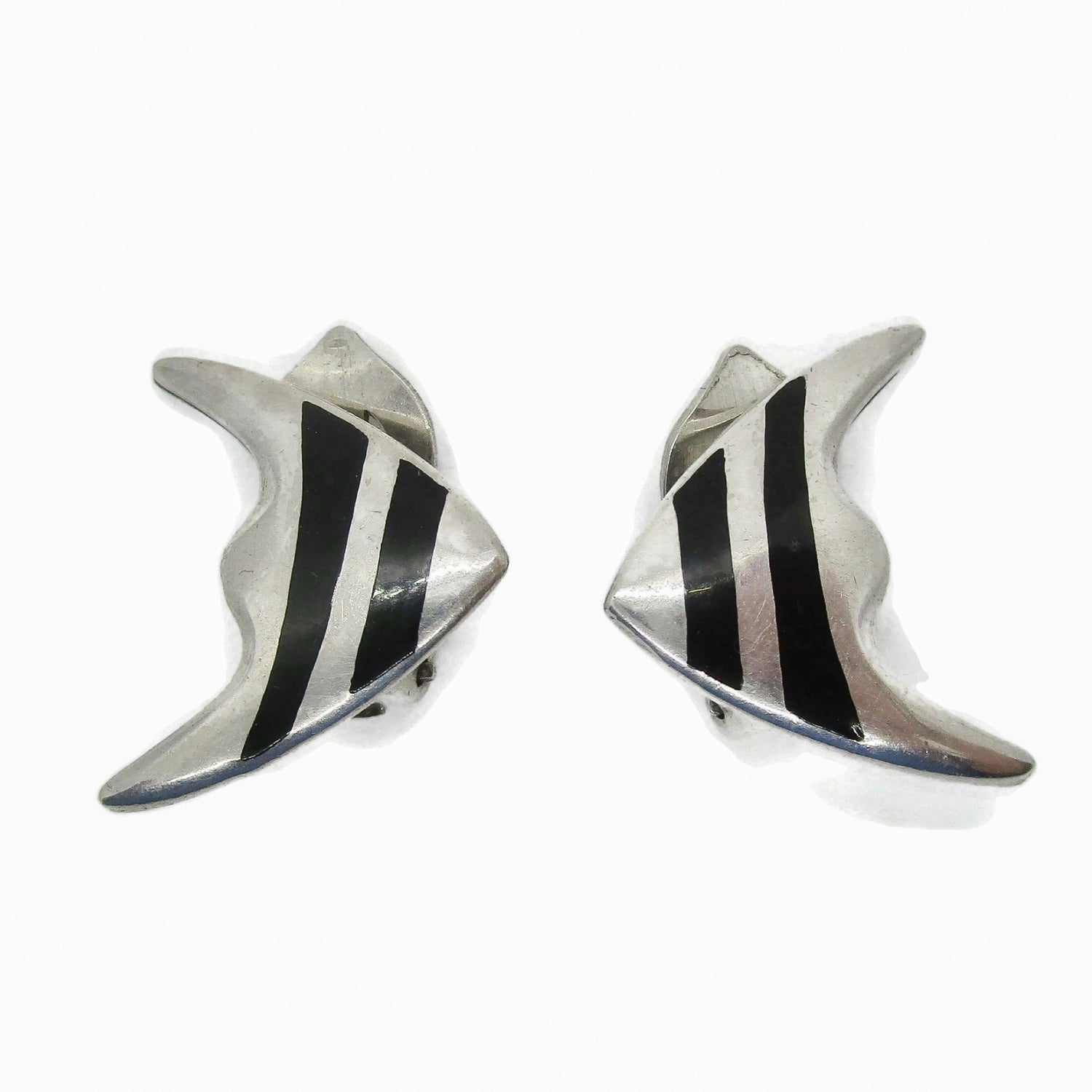 Front view of a pair of Meka sterling silver striped fish clip on earrings